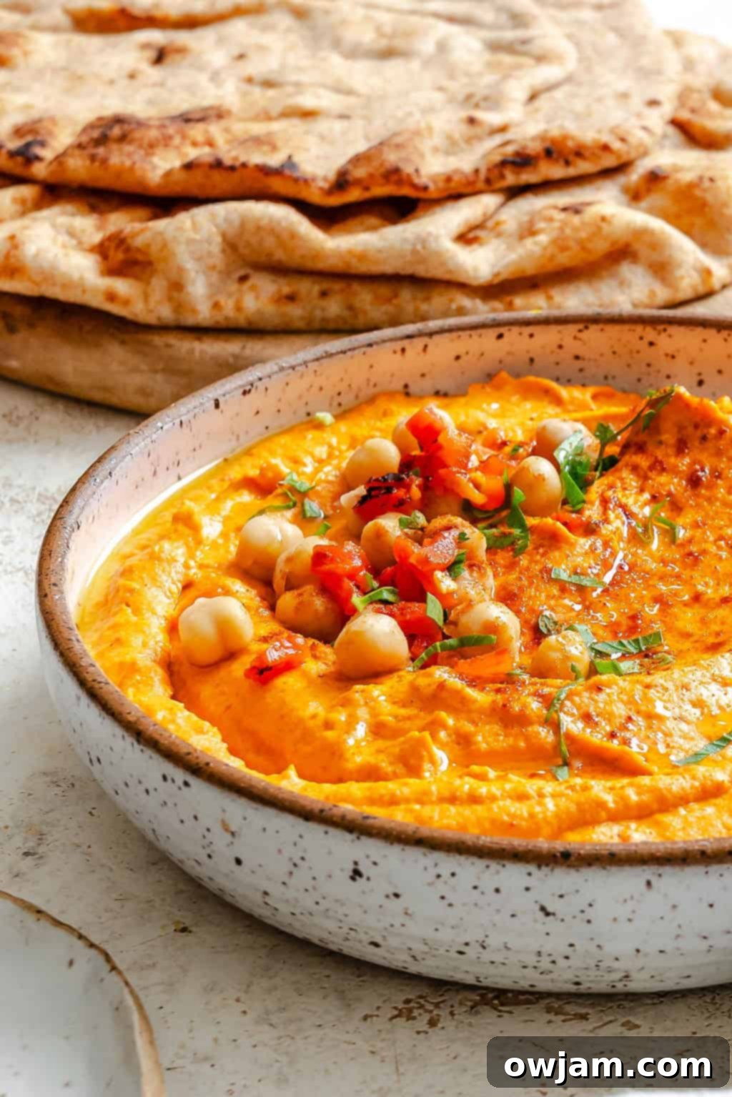Smoky Red Pepper Hummus 2 Roasted Red Pepper Hummus in a white bowl with pita