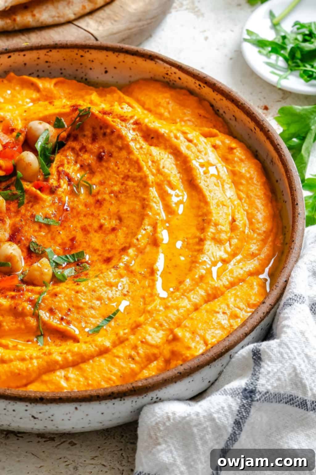 Smoky Red Pepper Hummus 4 Roasted Red Pepper Hummus with chickpeas and parsley for garnish