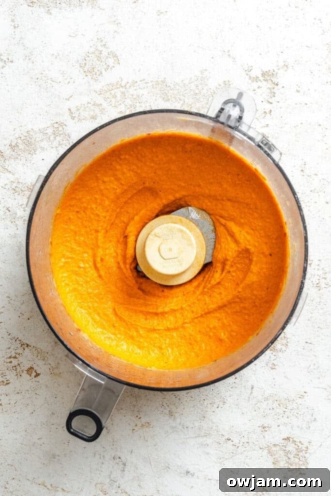 Smoky Red Pepper Hummus 6 Roasted Red Pepper Hummus pureed in a blender.