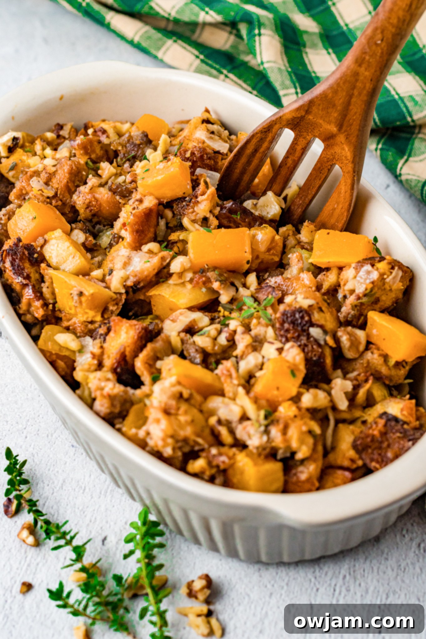 Autumn Butternut Dressing 2 A beautiful bowl of Butternut Squash Stuffing, garnished with fresh herbs, ready to be served.