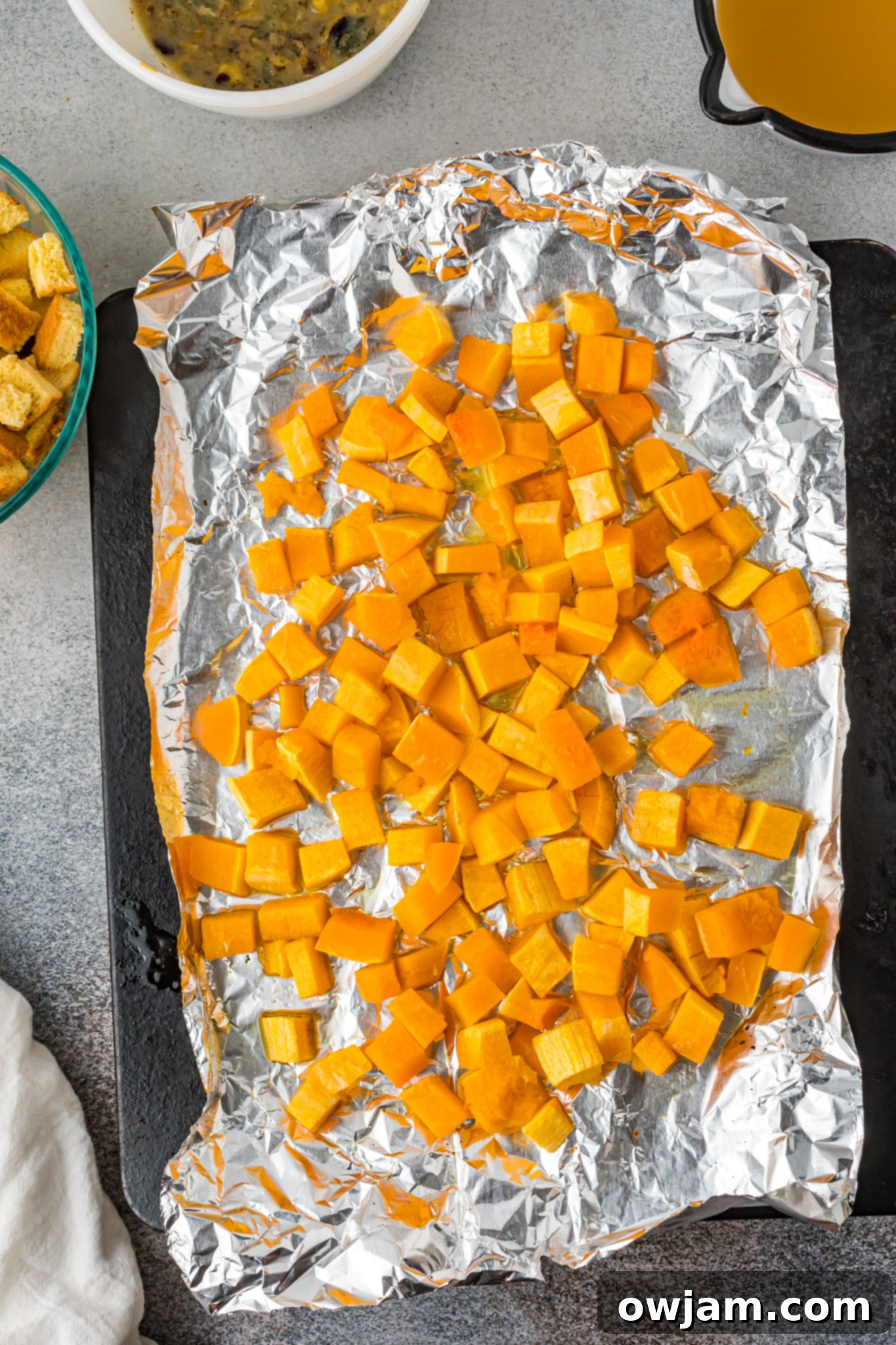 Autumn Butternut Dressing 5 Close-up of perfectly roasted butternut squash cubes, tender and slightly caramelized, ready to be added to the stuffing mixture.