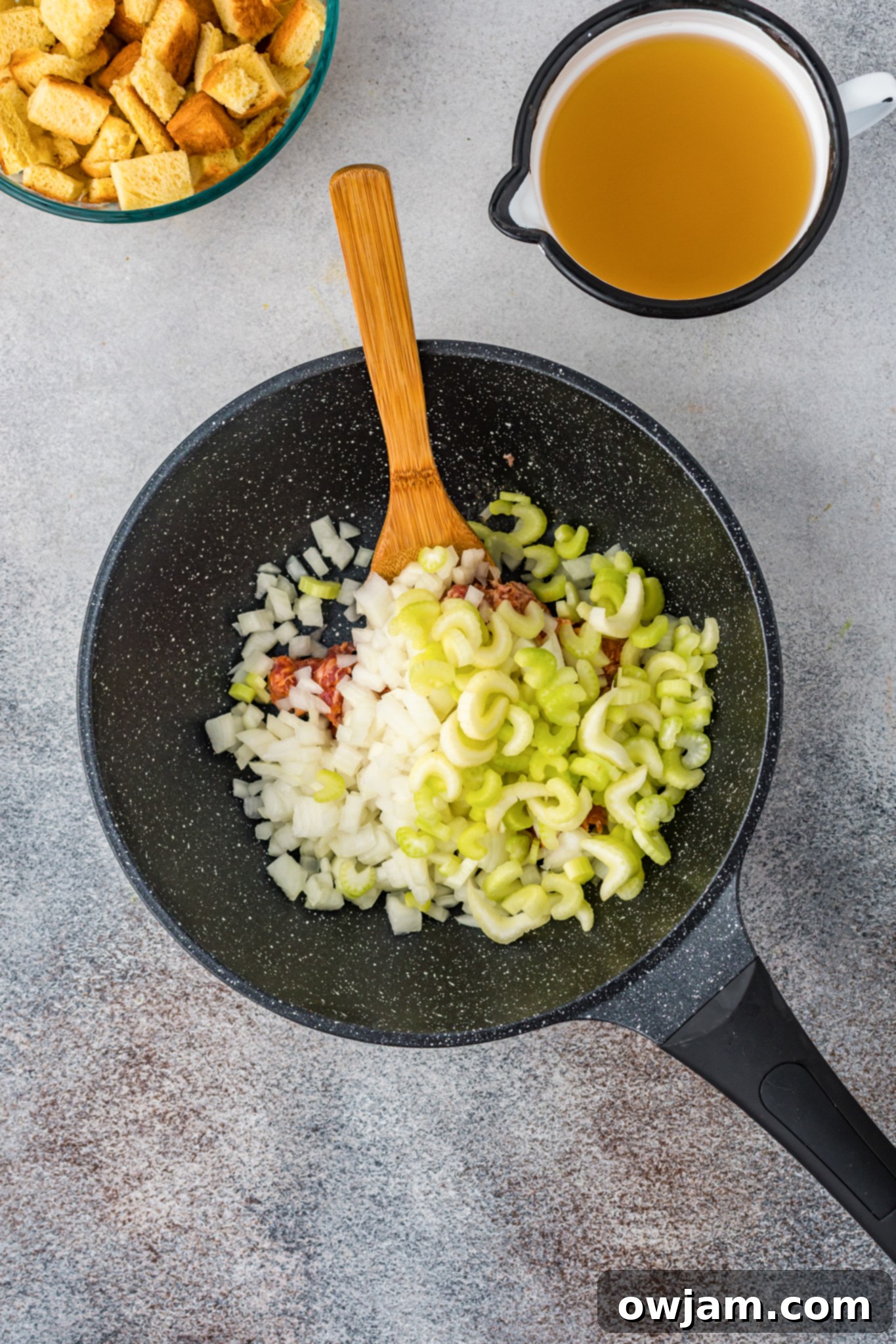 Autumn Butternut Dressing 7 Sautéed Italian sausage, diced onion, and celery cooking together in a large skillet, creating a flavorful base for the stuffing.