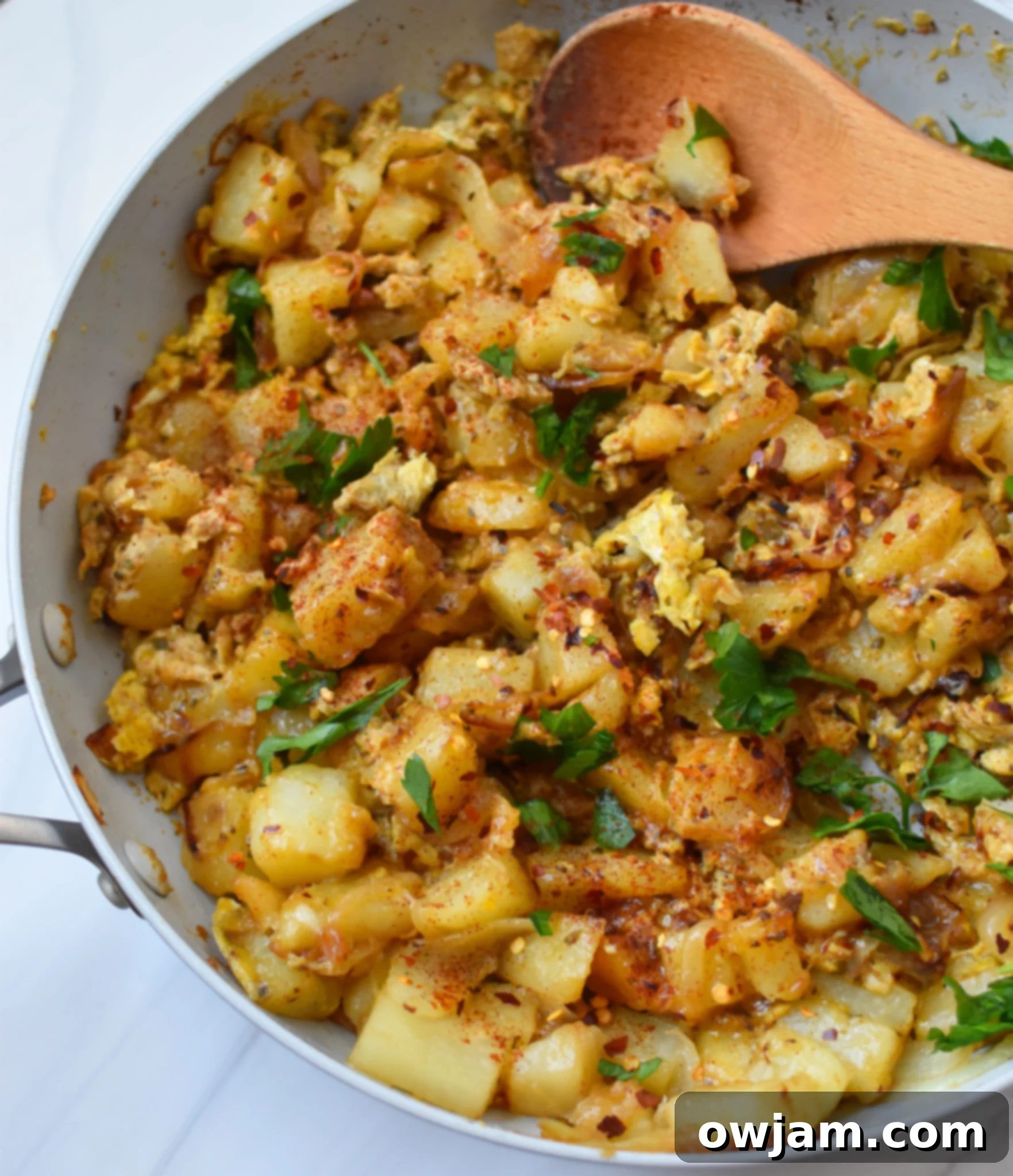 Savory Lebanese Potato and Egg Dish 2 Lebanese Potato and Egg Recipe in a pan, garnished with parsley.
