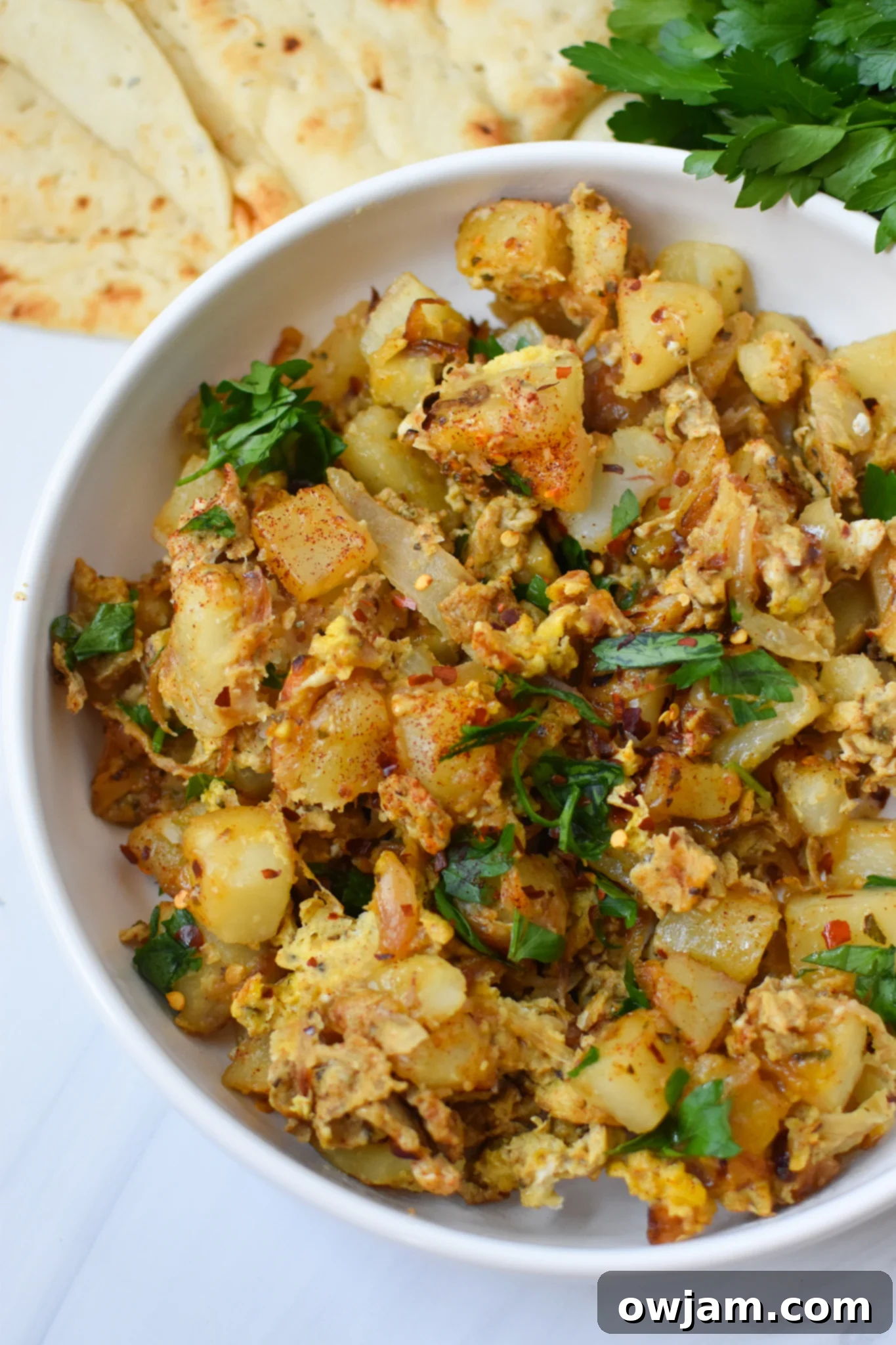 Savory Lebanese Potato and Egg Dish 5 Lebanese Potato and Egg Recipe garnished generously with fresh parsley.
