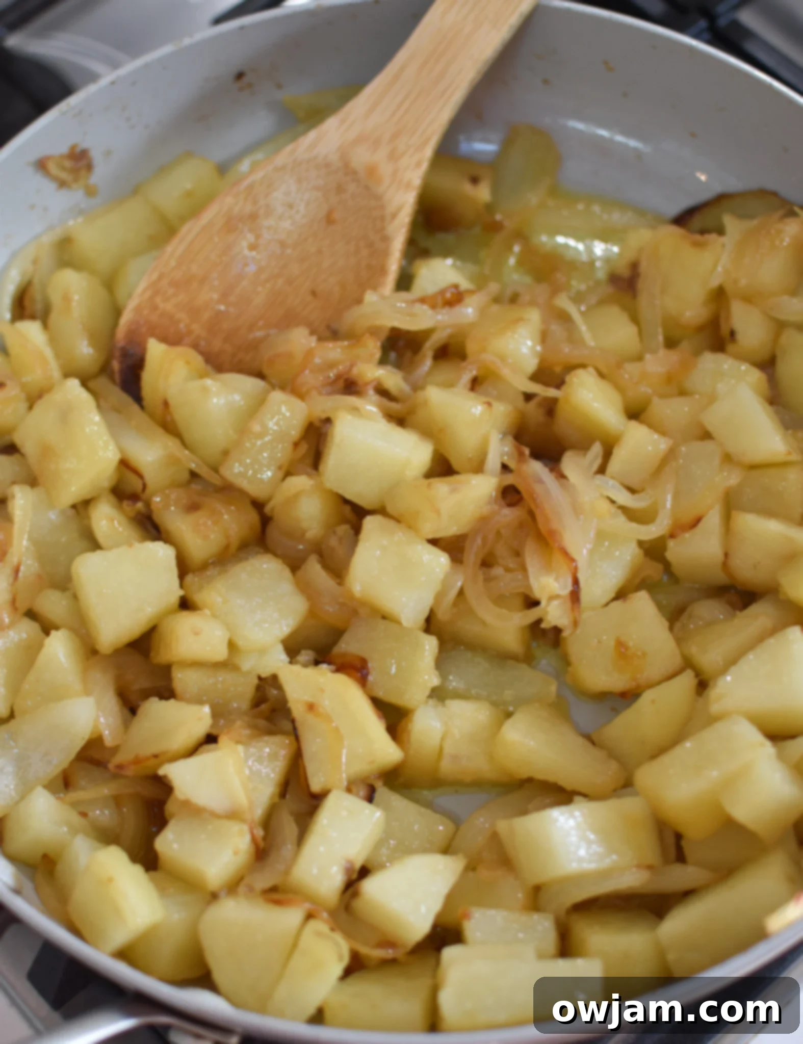 Savory Lebanese Potato and Egg Dish 8 Sautéing potatoes and onions together in a skillet for Lebanese Potato and Egg Recipe.