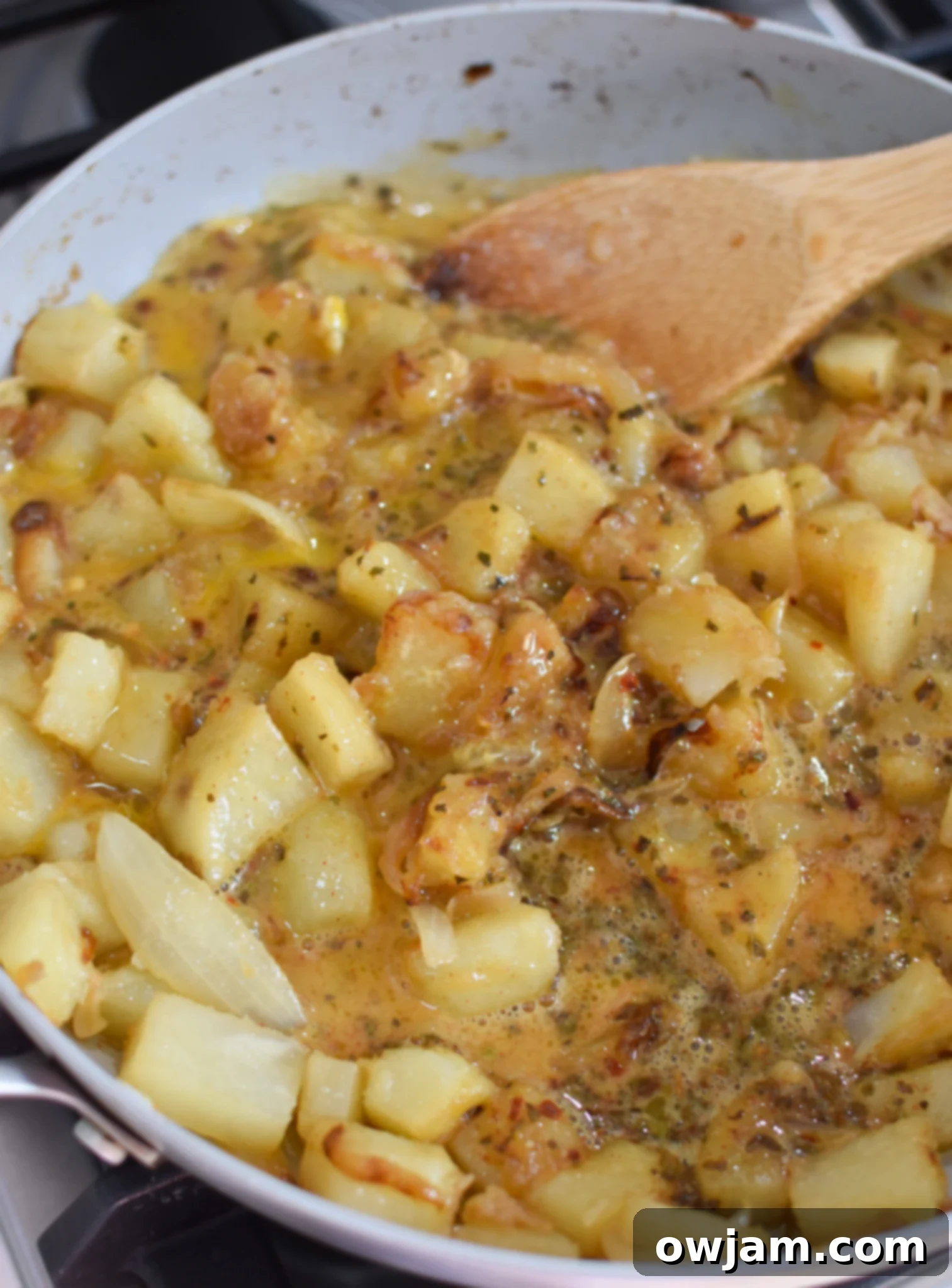 Savory Lebanese Potato and Egg Dish 10 Lebanese Potato and Egg Recipe with eggs cooking in a skillet with the potatoes.