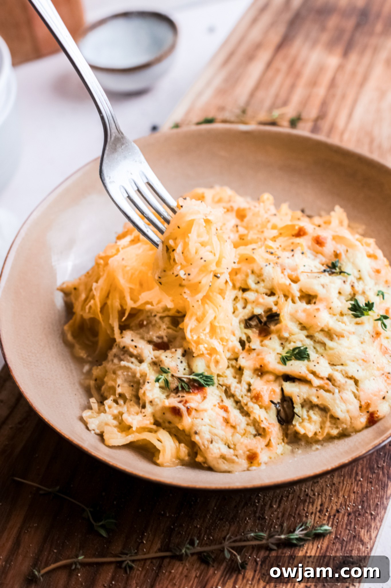 Close-up of Baked Cheesy Spaghetti Squash Recipe with a fork lifting some strands.