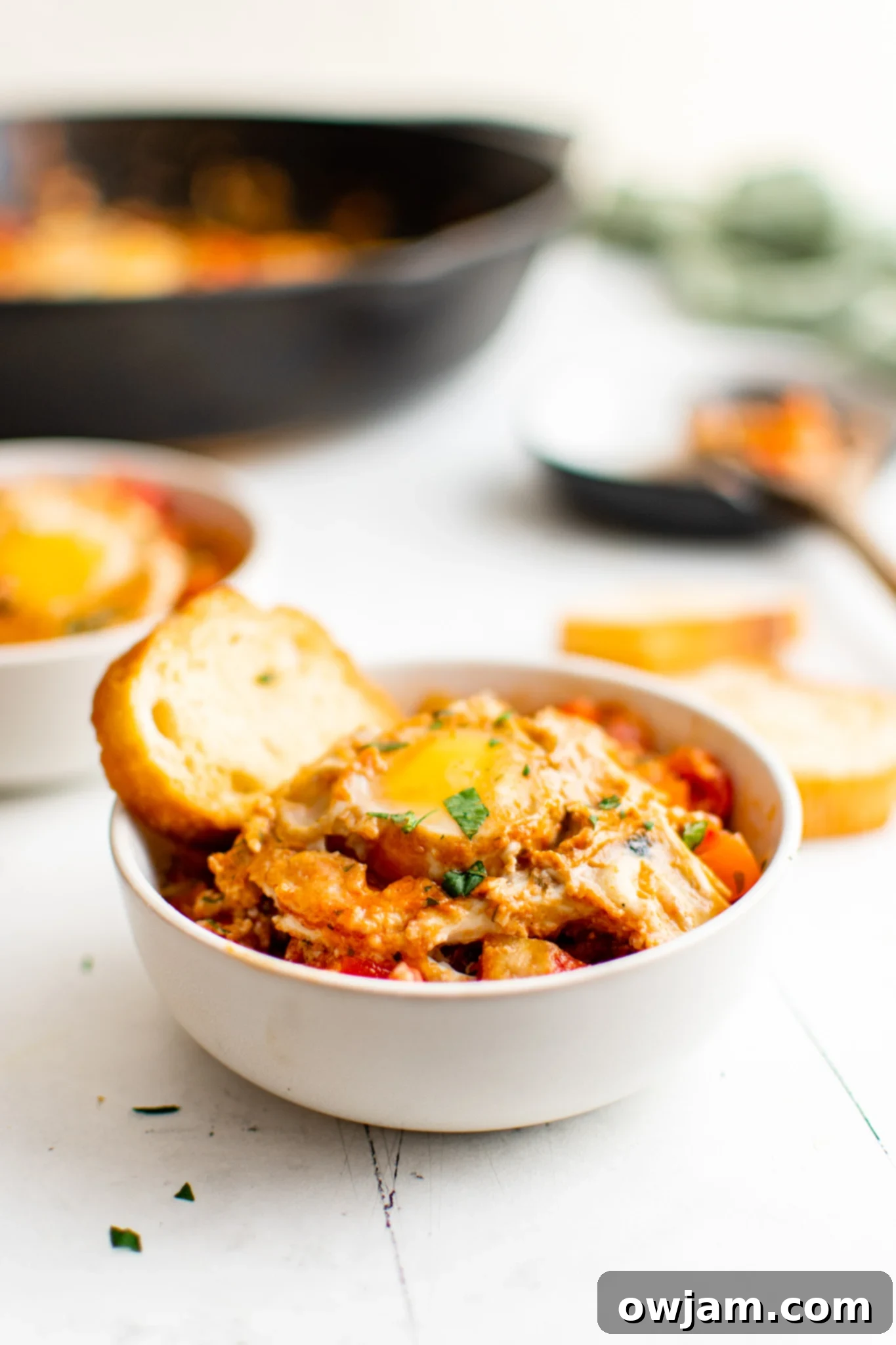 Effortless Shakshuka 12 Easy Shakshuka served with warm pita bread.