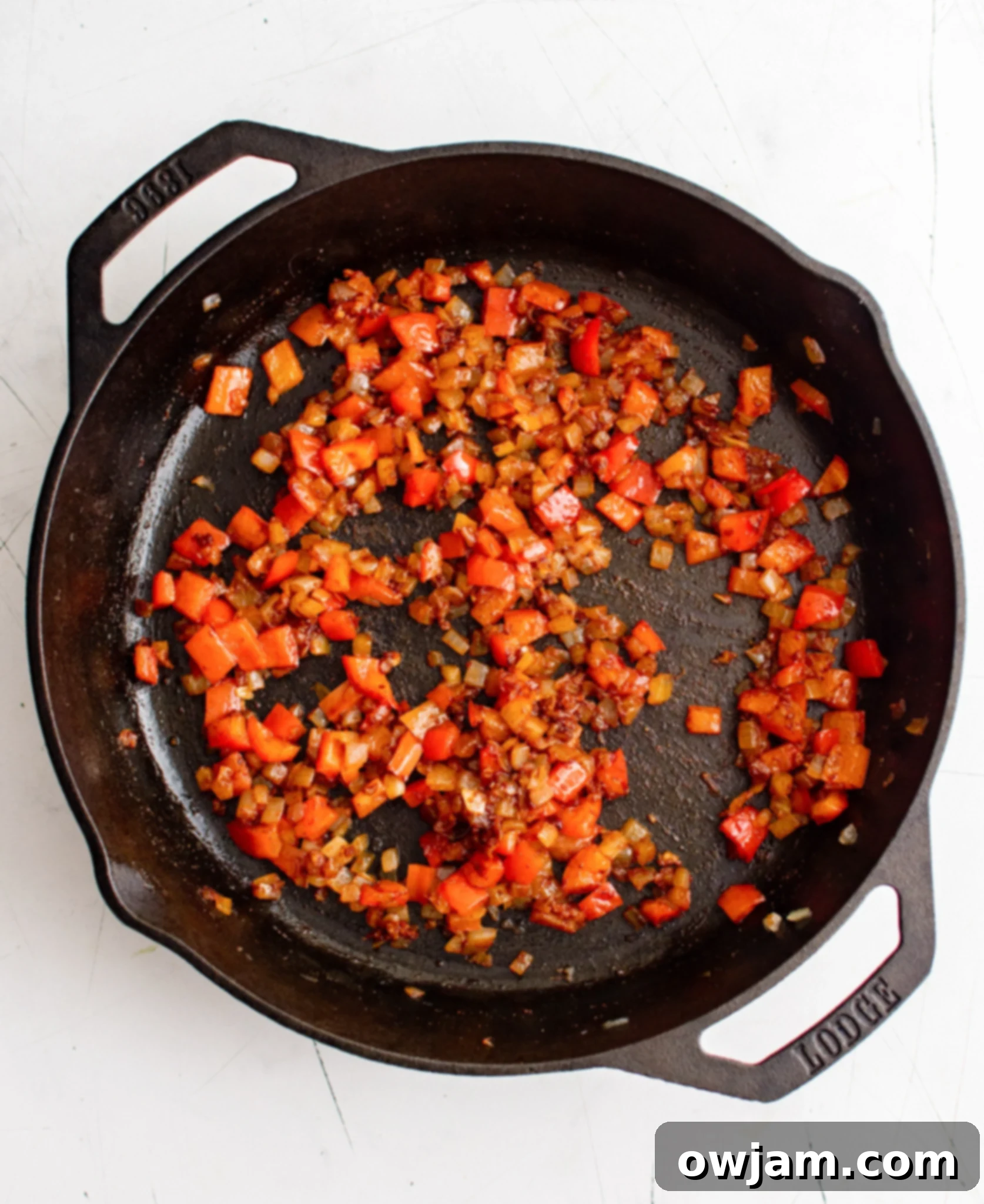 Effortless Shakshuka 7 Sautéing bell peppers and onions with spices for Shakshuka base.