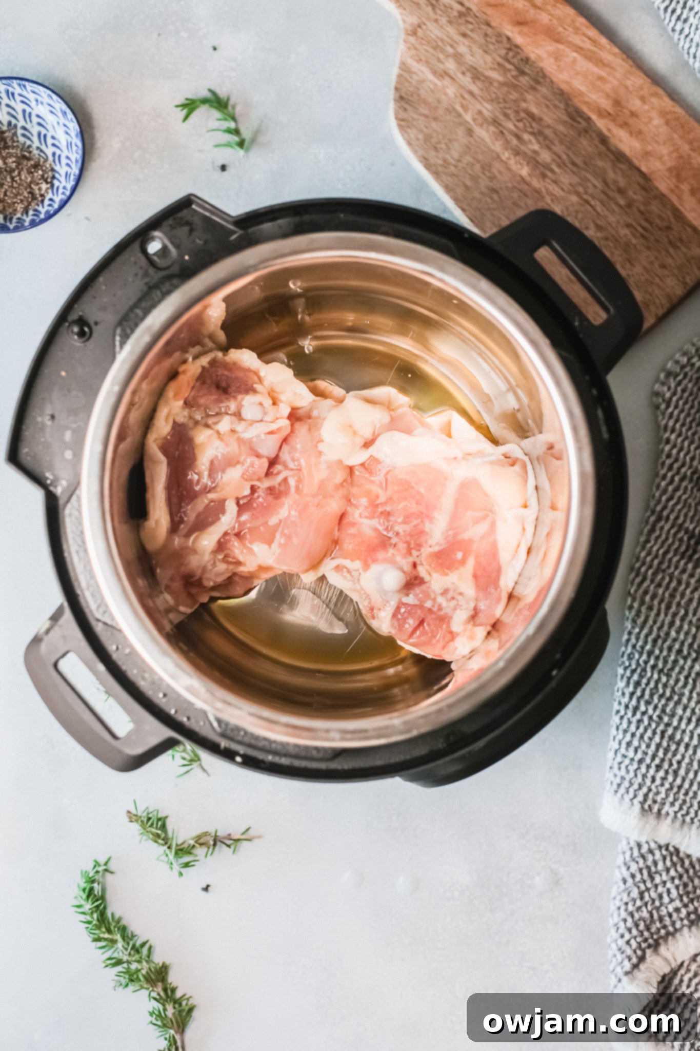 Delicious Instant Pot Creamy Rosemary Chicken 5 Sautéing Instant Pot Creamy Rosemary Chicken thighs in the Instant Pot.