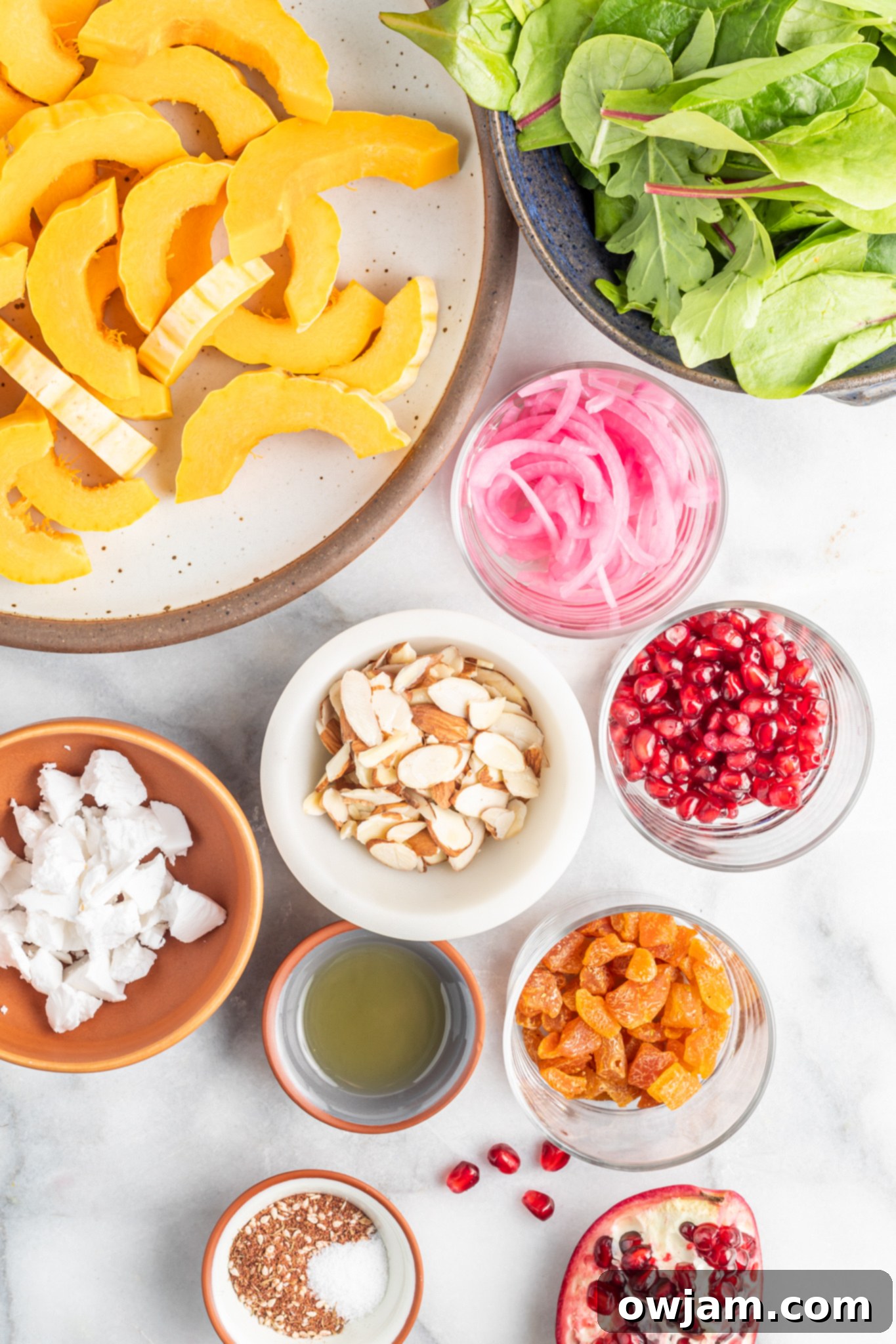 Close-up of the fresh ingredients for Za'atar Roasted Delicata Squash, including whole delicata squash, za'atar spice, and olive oil.
