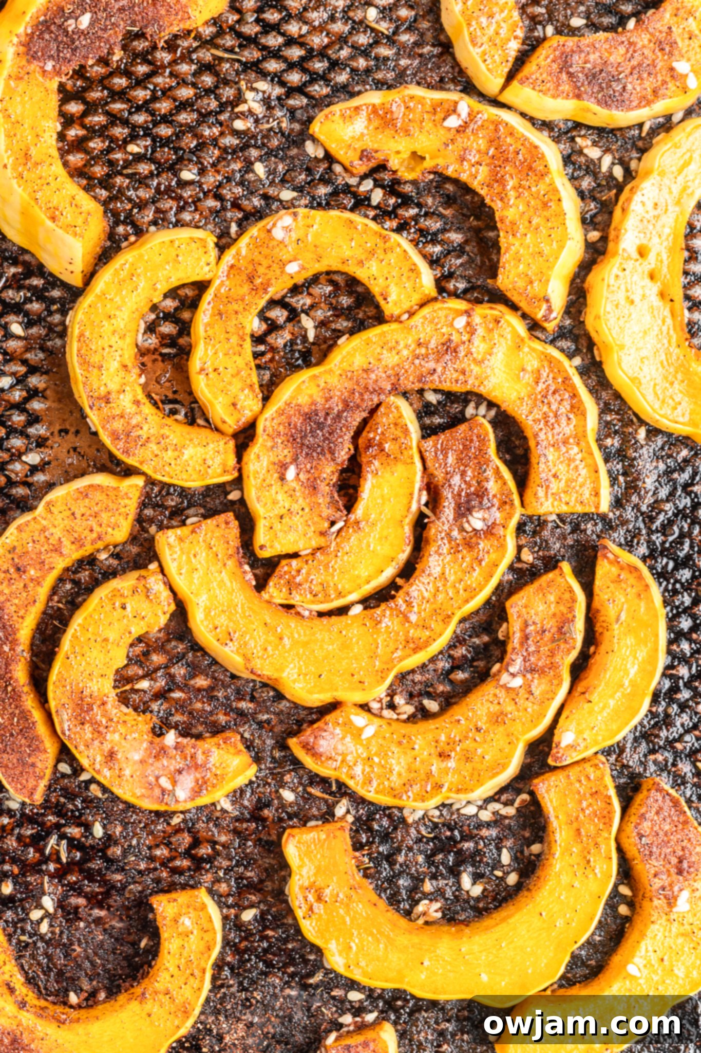 Roasted Za'atar Delicata Squash slices arranged on a baking sheet, fresh out of the oven.