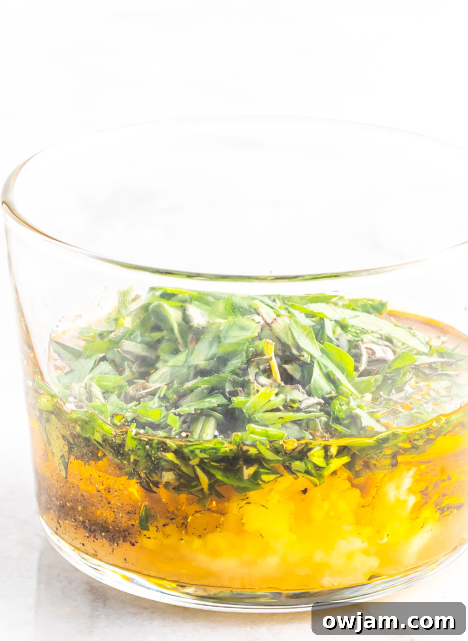 Homemade salad dressing in a glass container, ready to be drizzled over the Za'atar Roasted Delicata Squash salad.