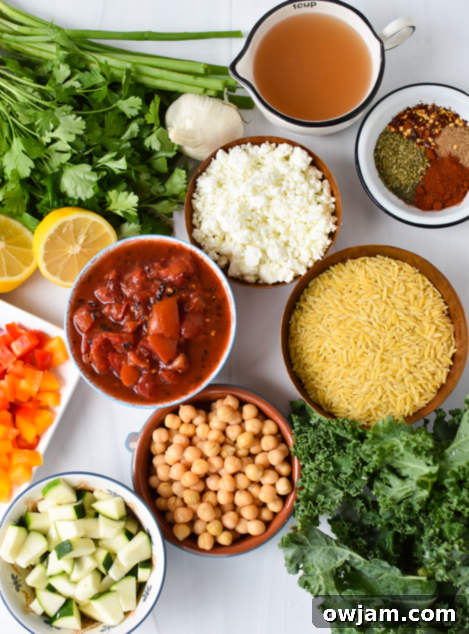 Assorted Mediterranean Orzo Pasta Recipe ingredients laid out.