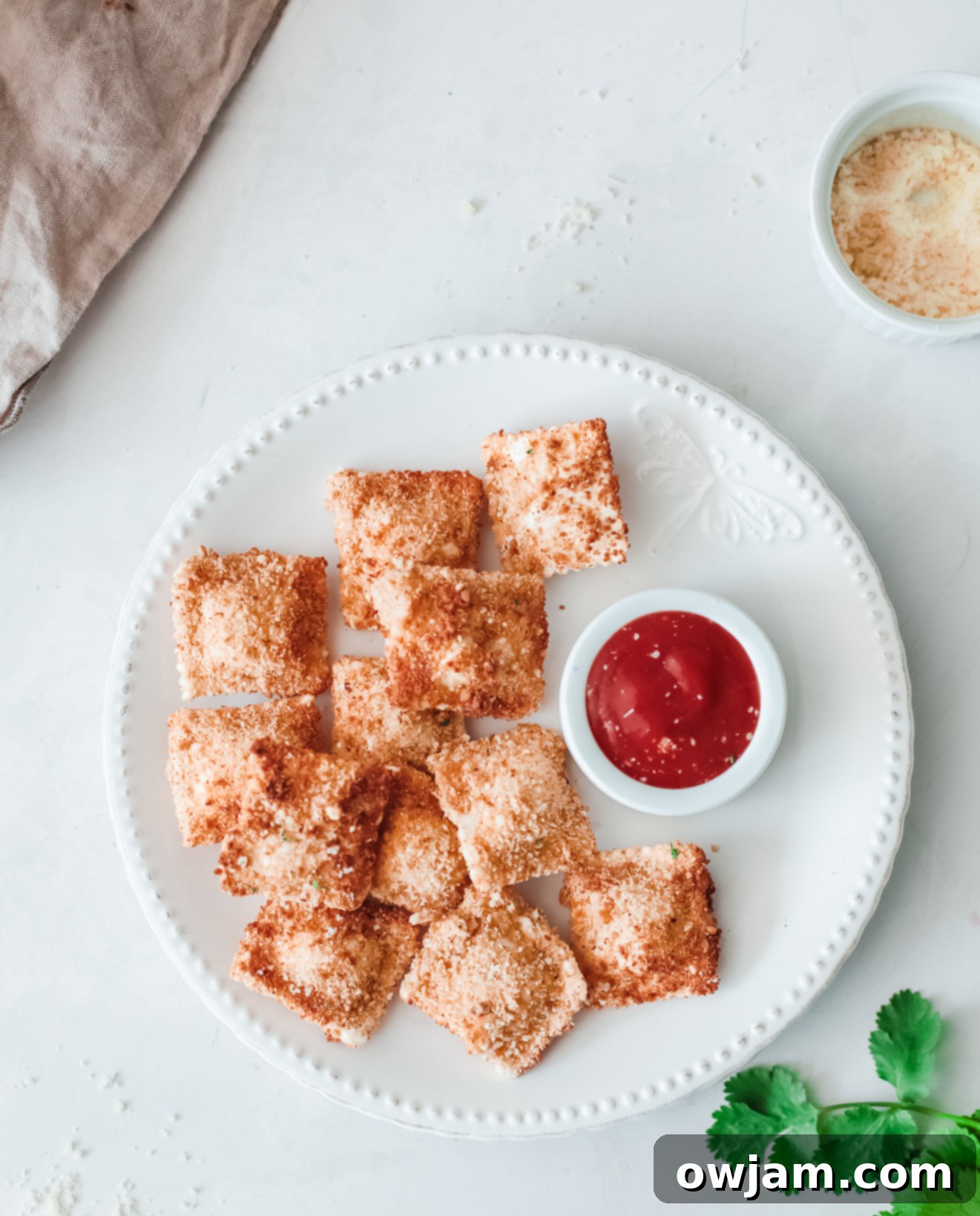 Crispy Air Fried Ravioli on a plate with a decorative napkin.
