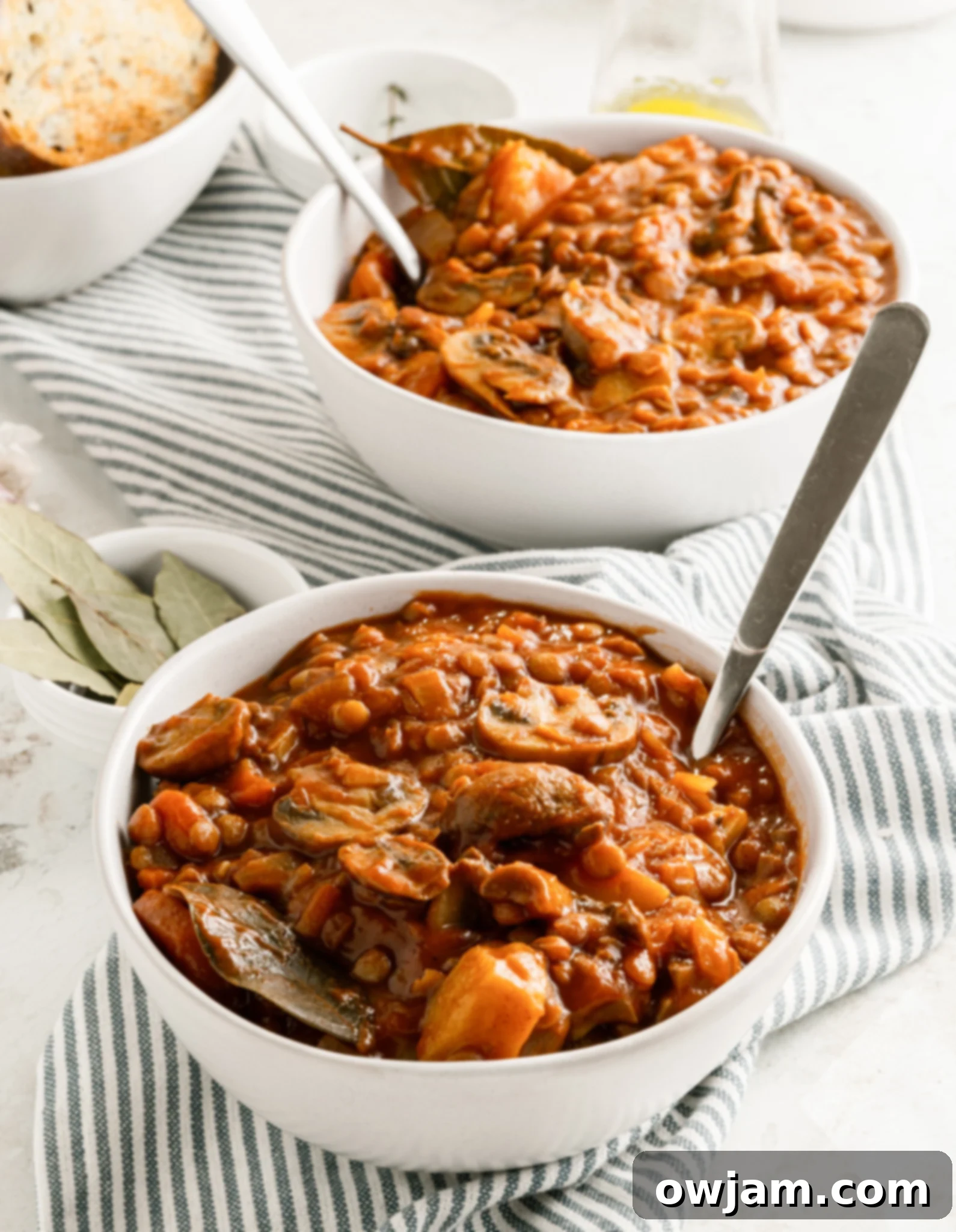 Lentil Mushroom Stew in white bowls, beautifully garnished.