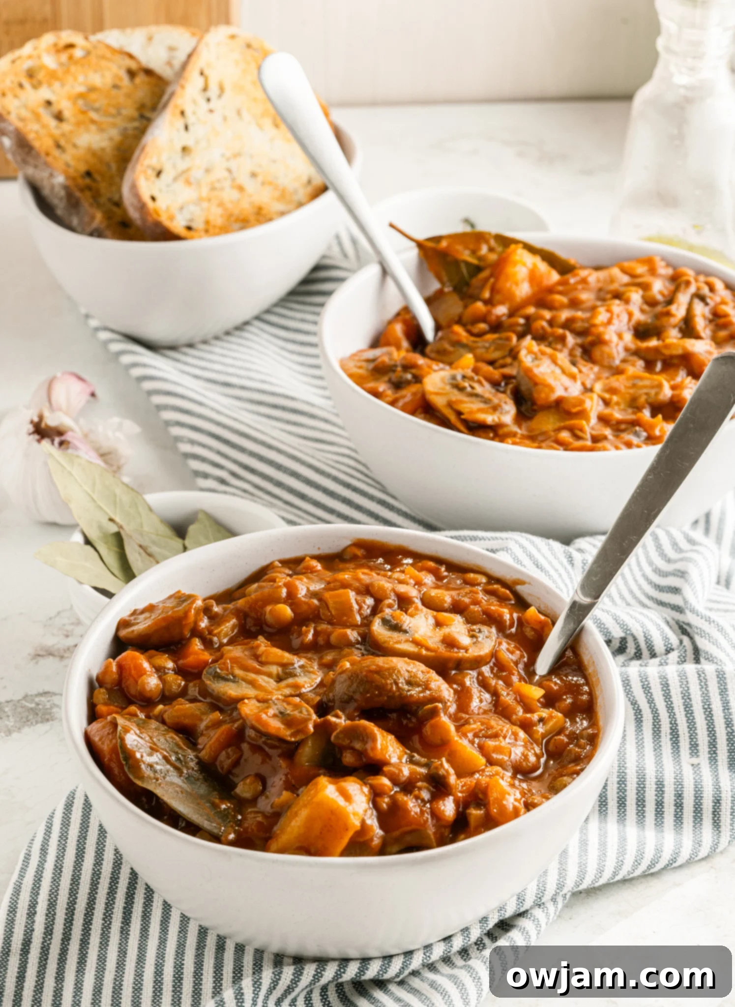 Lentil Mushroom Stew in two white bowls, ready to be enjoyed.