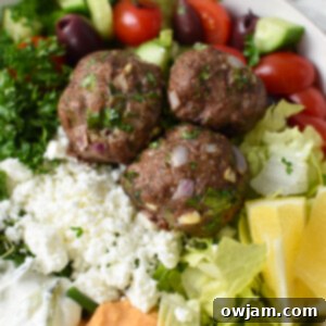 Oven-Baked Mediterranean Beef Meatballs 11 Mediterranean Baked Beef Meatballs in a hummus bowl.
