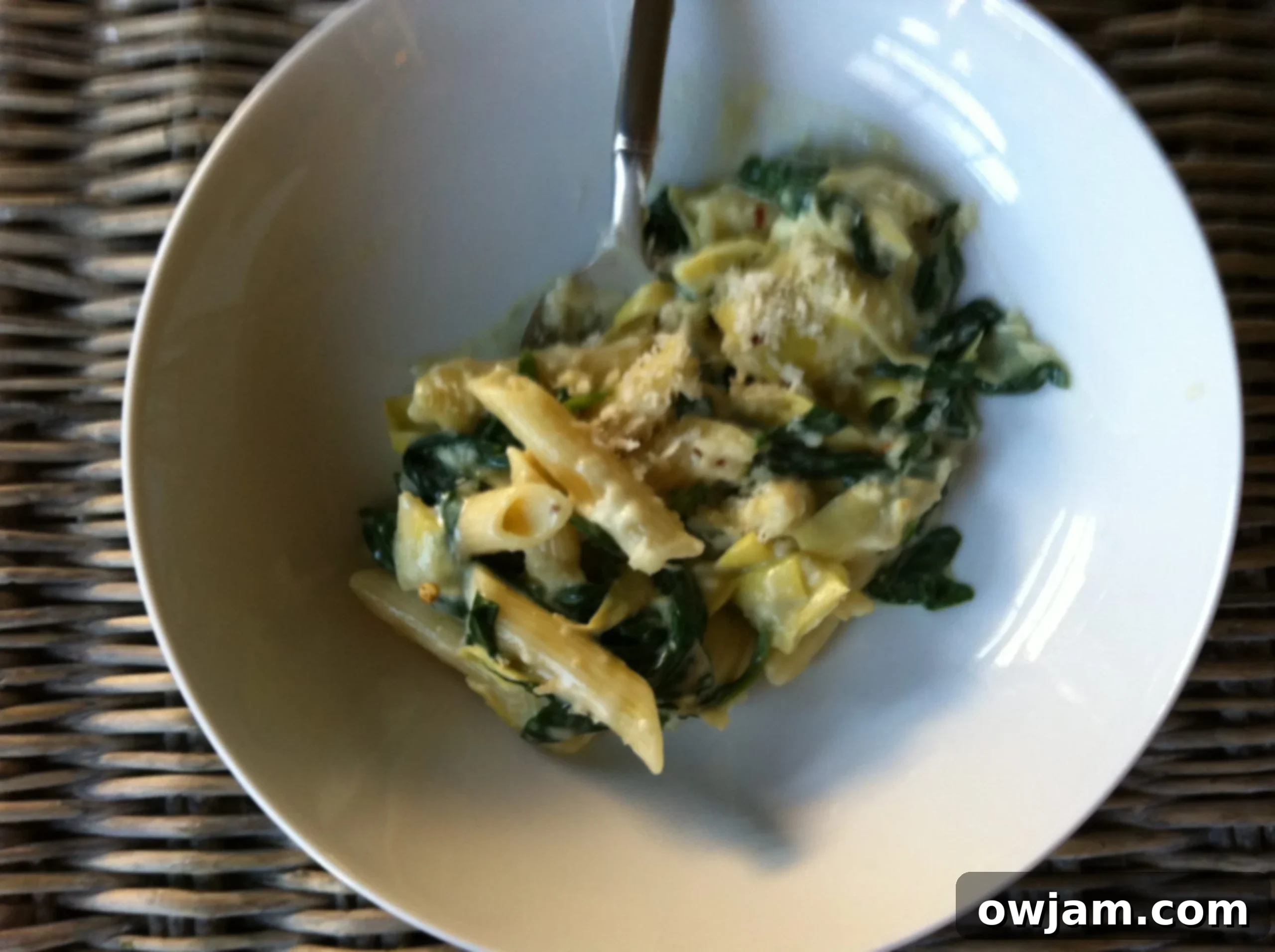 Ingredients for spinach artichoke pasta on a counter, ready for cooking