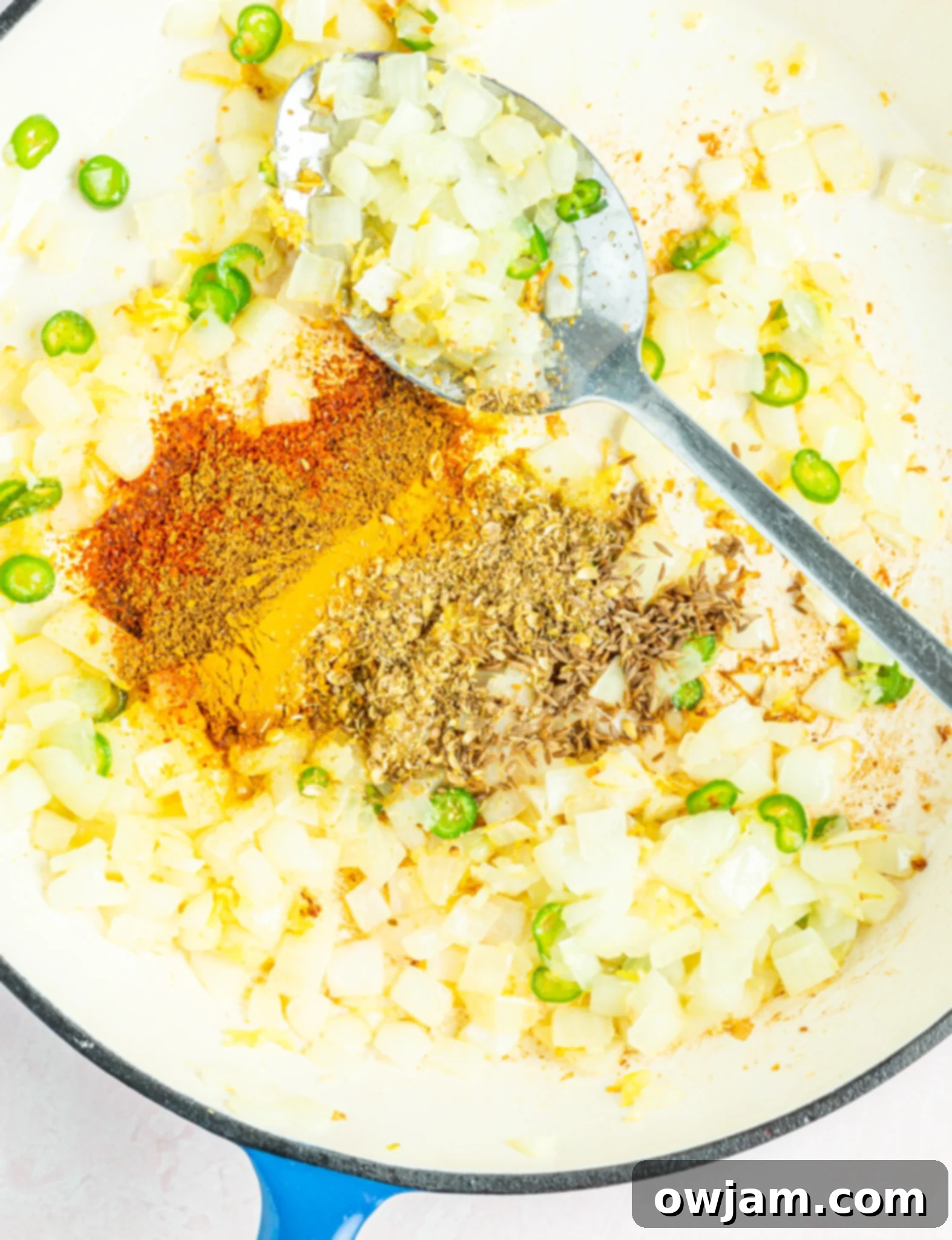 Golden Cauliflower Curry 6 Diced yellow onions sautéing in a hot skillet, becoming translucent for the curry base.
