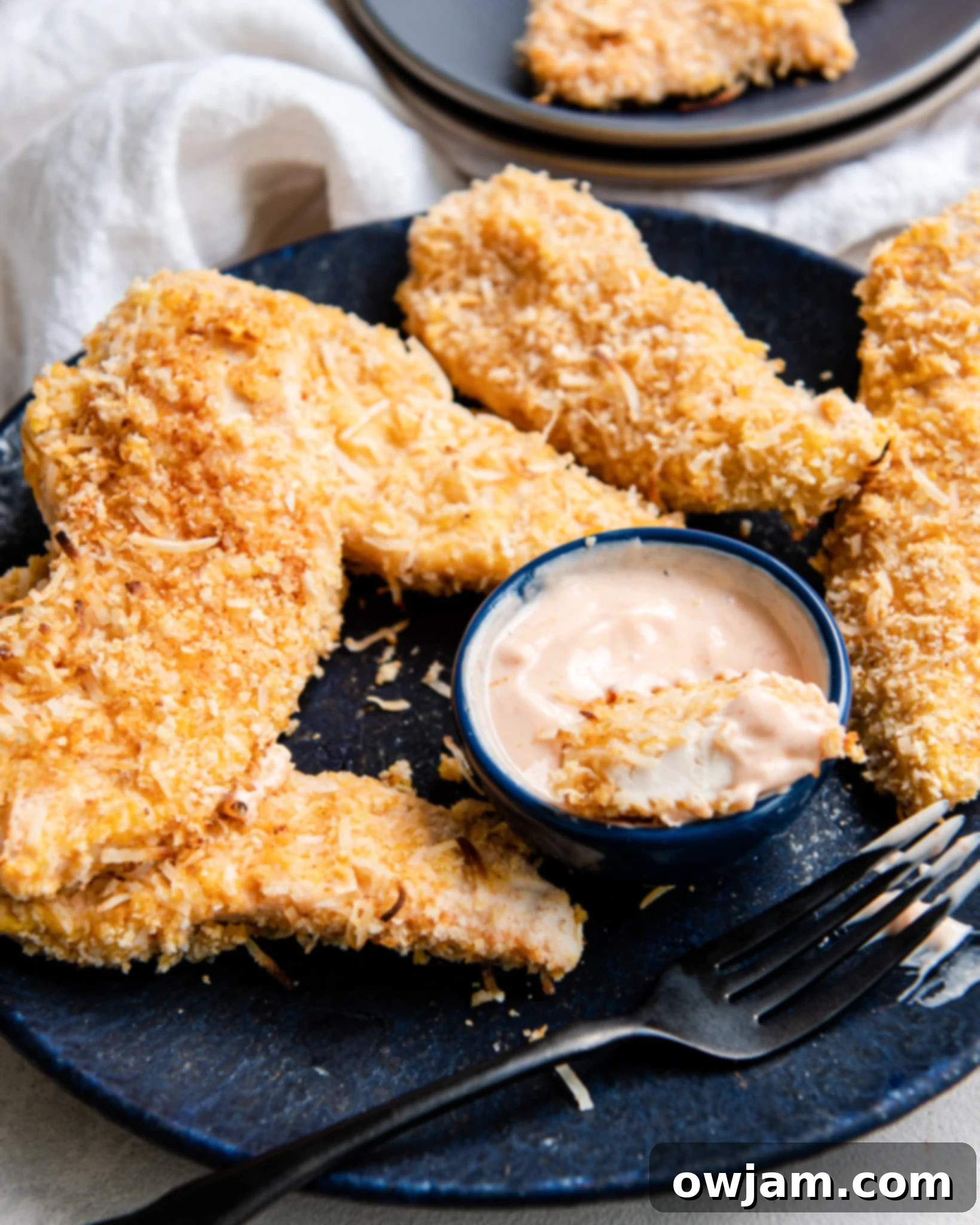 Air Fryer Coconut Chicken Tenders with sauce.