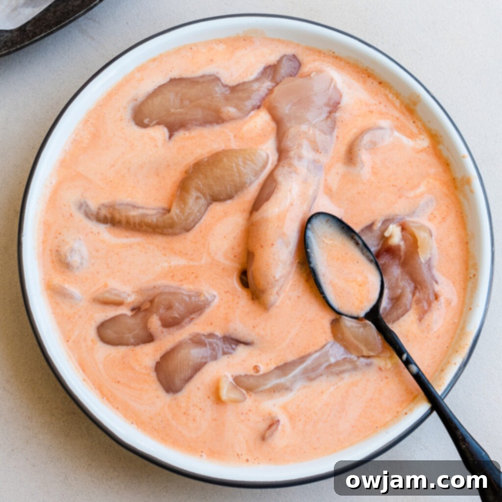 Air Fryer Coconut Chicken Tenders in a buttermilk mixture.