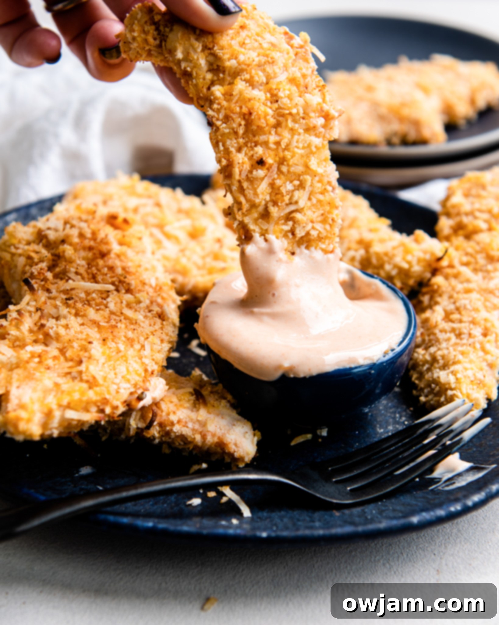 Air Fryer Coconut Chicken Tenders with sauce.