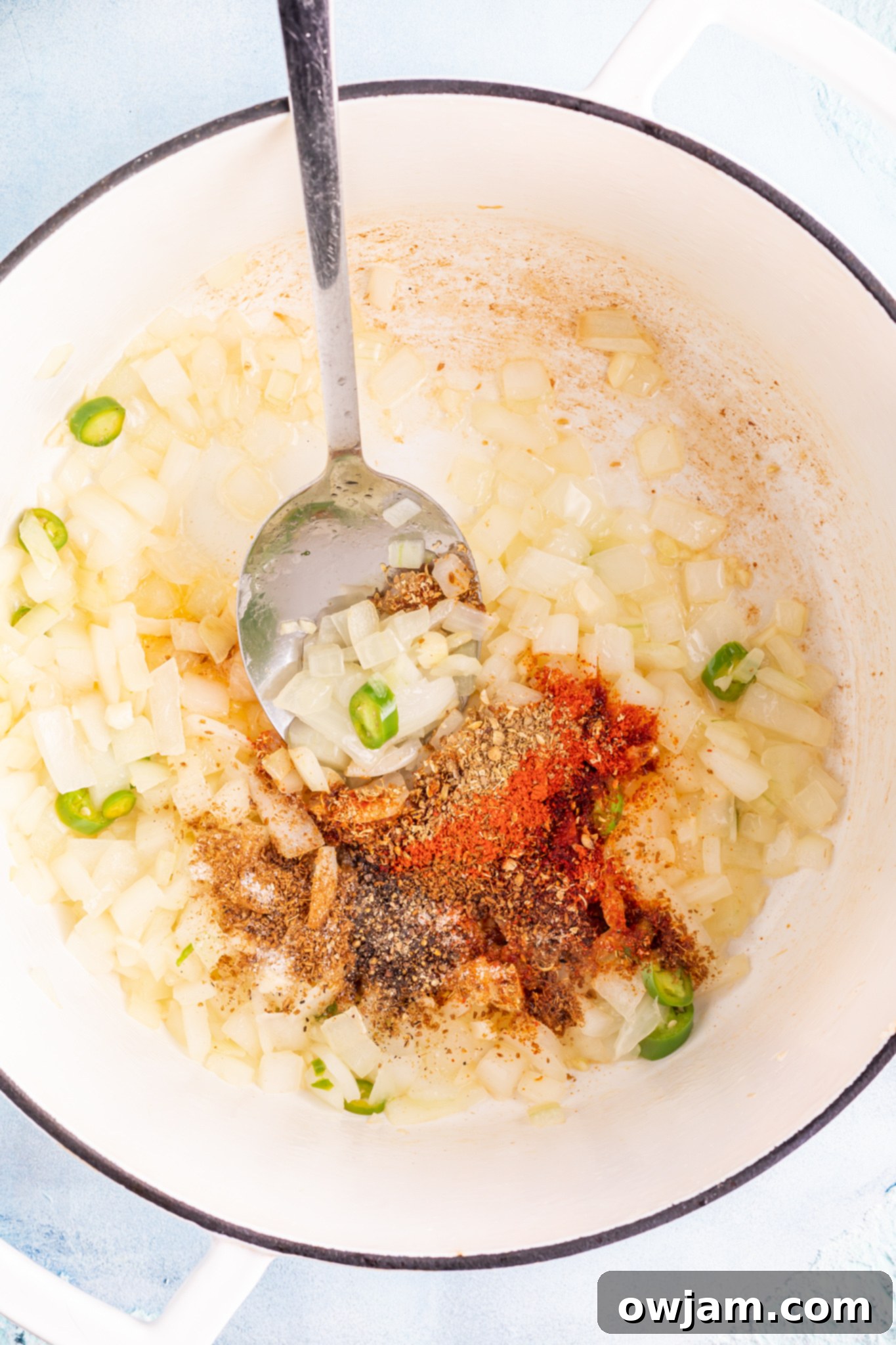 Comforting Pinto Bean Soup 5 Vegan Pinto Bean Soup with spices being added to the dutch oven.