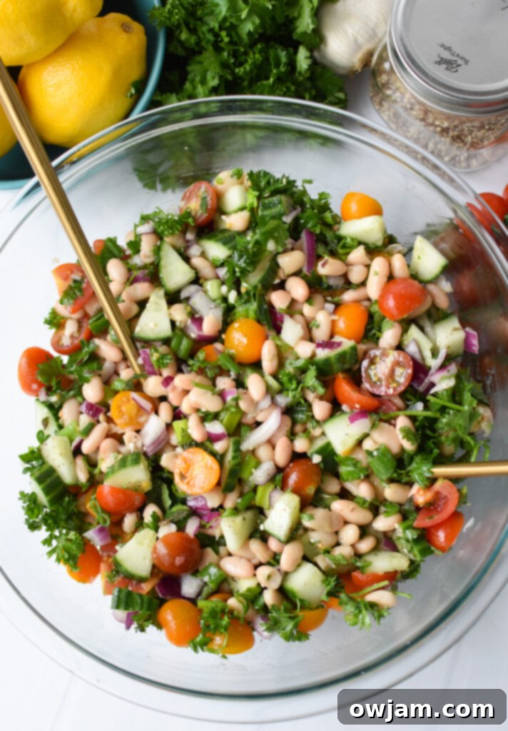 Sun Drenched White Bean Medley 7 Mediterranean White Bean Salad served with gold serving spoons, ready for sharing.