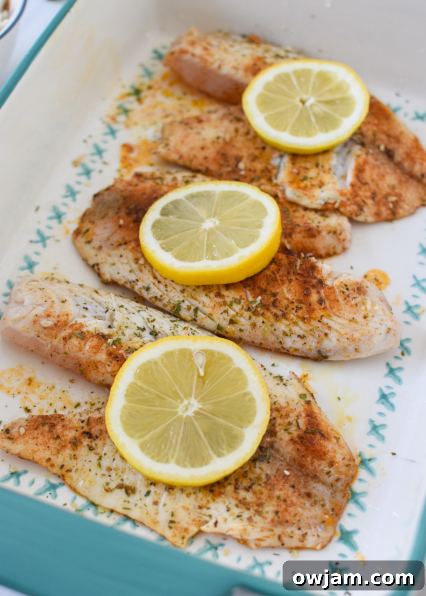 Greek Baked Tilapia in a pan ready to be baked.