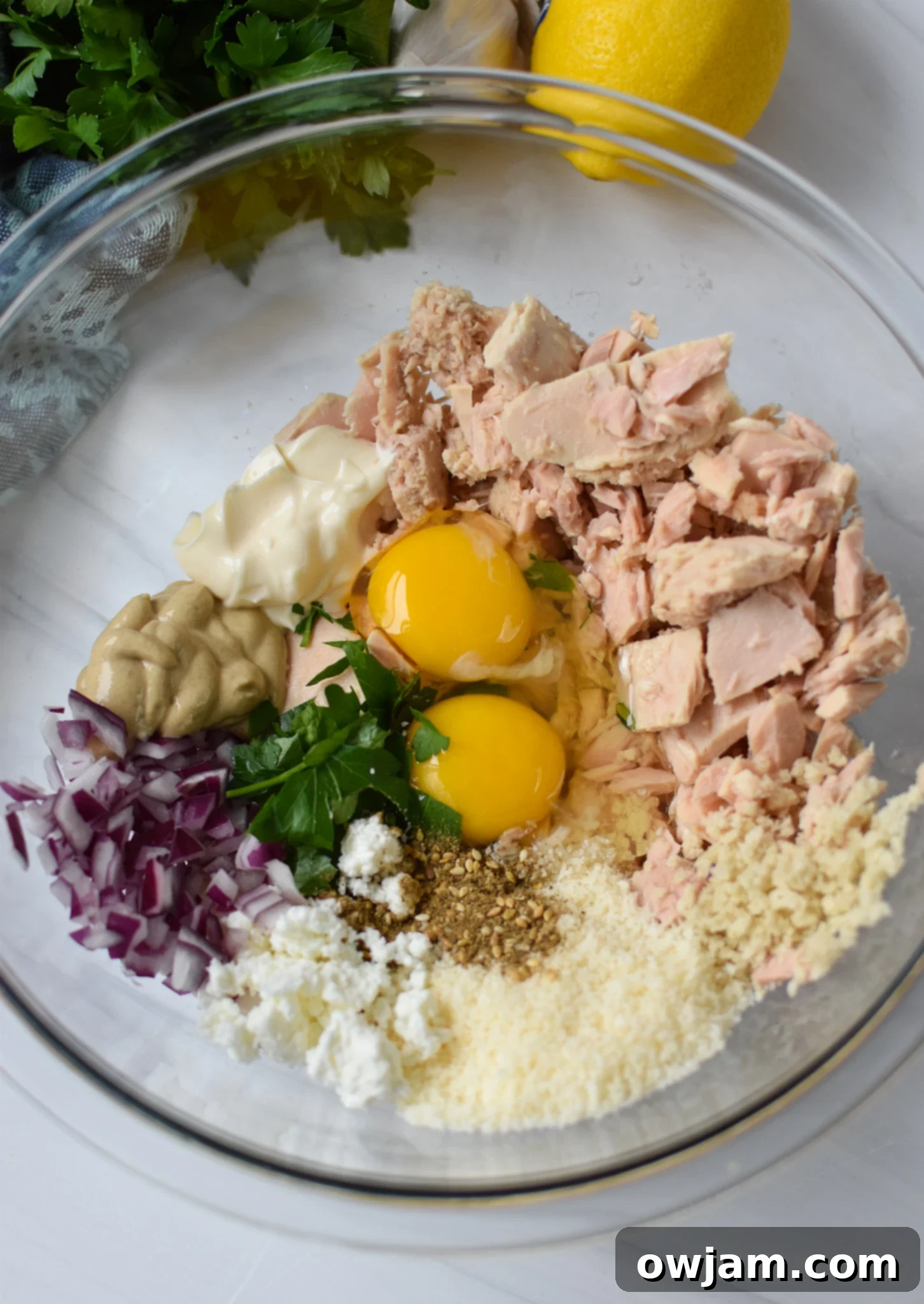 All the Mediterranean Tuna Patties Recipe ingredients mixed together in a large bowl before forming patties.
