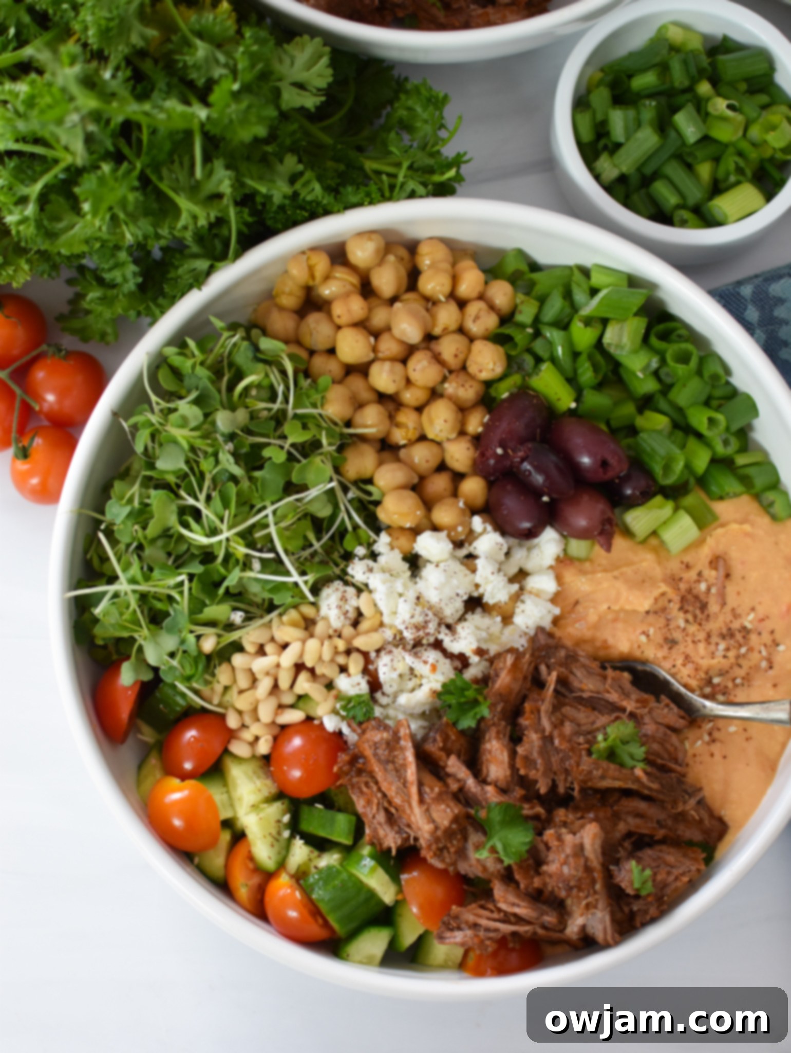 Mediterranean Shredded Beef Hummus Bowls 4 Close-up of Mediterranean olives and creamy hummus, key components of the beef hummus bowls.
