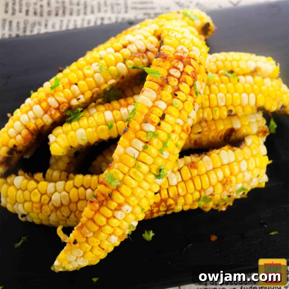 23 Irresistible Sides to Elevate Your Taco Night 24 A plate of crispy Corn Ribs with a delectable garlic butter sauce, a fun and delicious way to enjoy corn, served as a side dish.