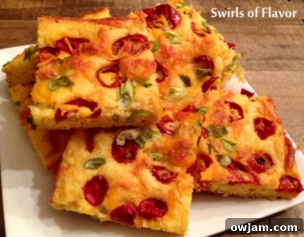 23 Irresistible Sides to Elevate Your Taco Night 25 A slice of golden-brown Jalapeno Cheddar Cornbread, with visible jalapeño pieces and melted cheddar cheese throughout.