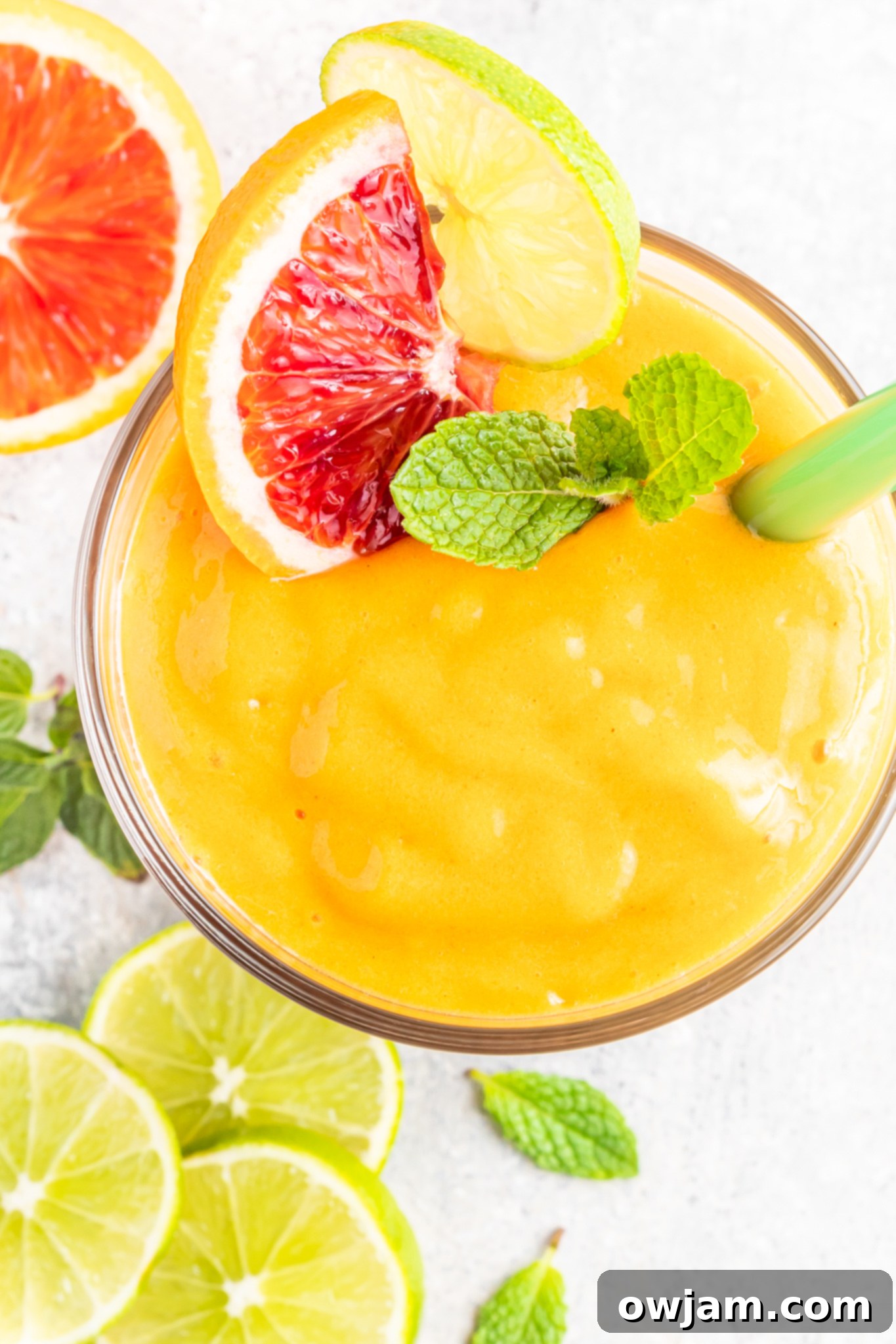Beautiful Orange Smoothie garnished with fresh orange slices and mint leaves.