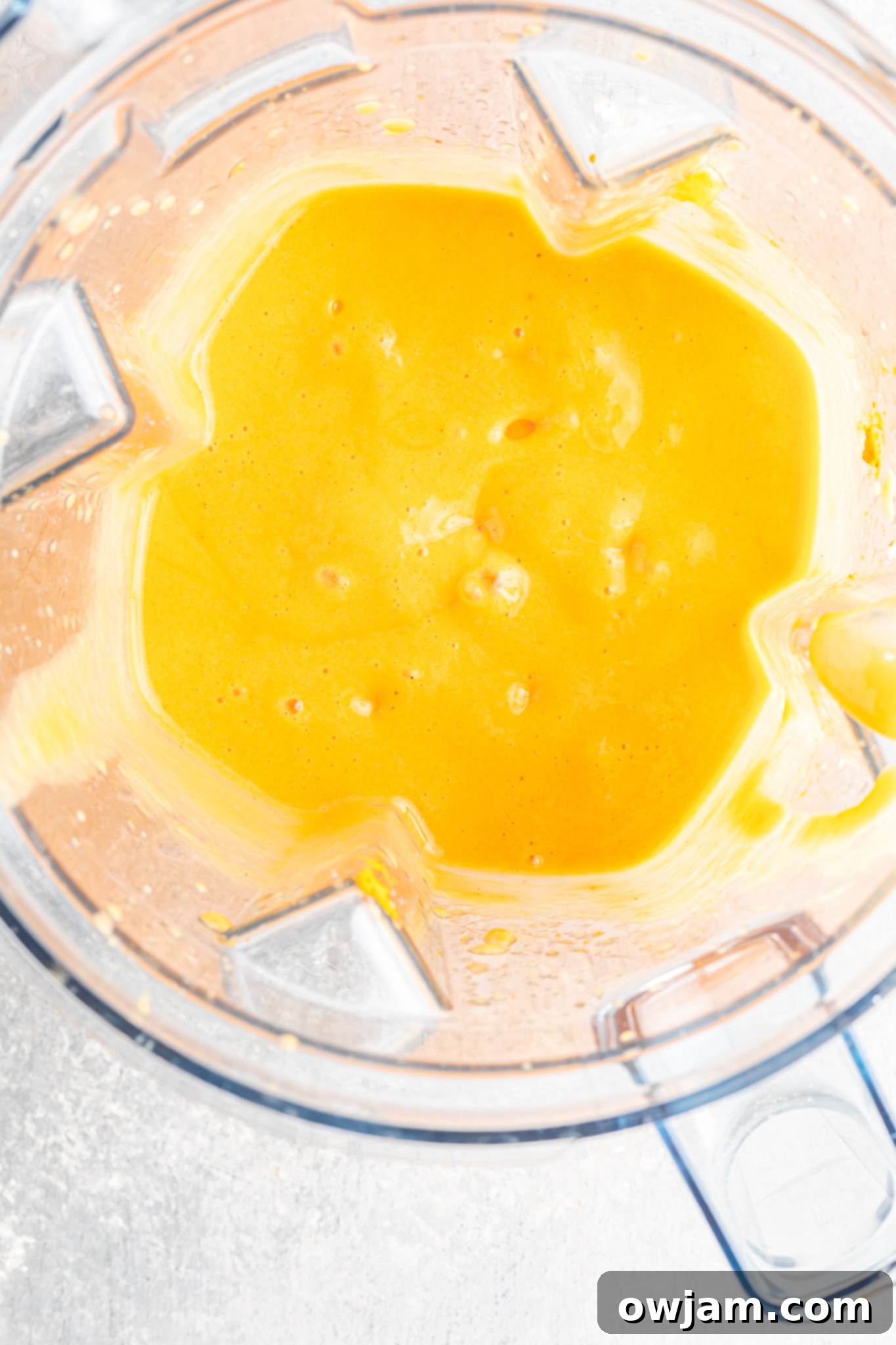 Orange Smoothie ingredients ready for blending in a powerful blender.