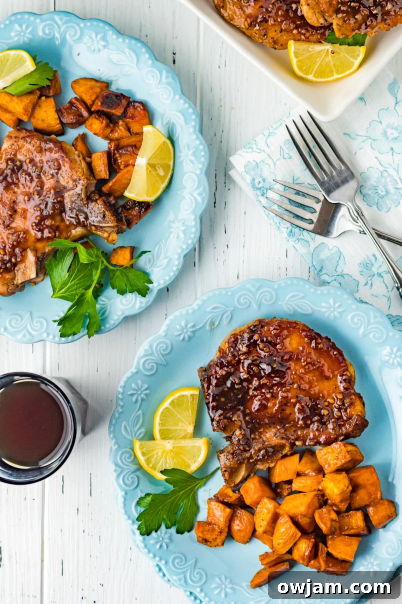 Maple Bourbon Glazed Pork Chops Recipe 13 Maple Bourbon Pork Chops Recipe on blue plates with roasted sweet potatoes.