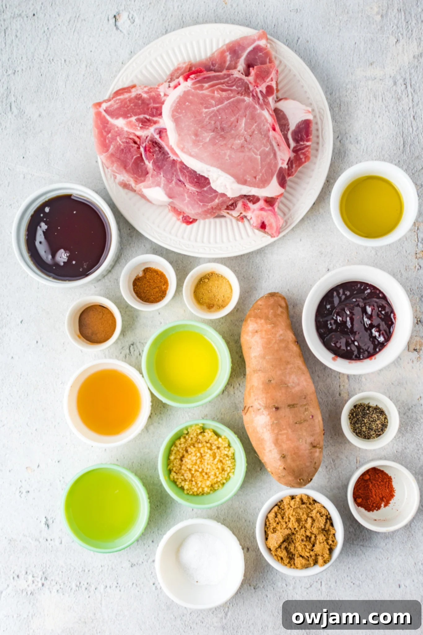 Maple Bourbon Glazed Pork Chops Recipe 4 Maple Bourbon Pork Chops Recipe ingredients laid out on a board.