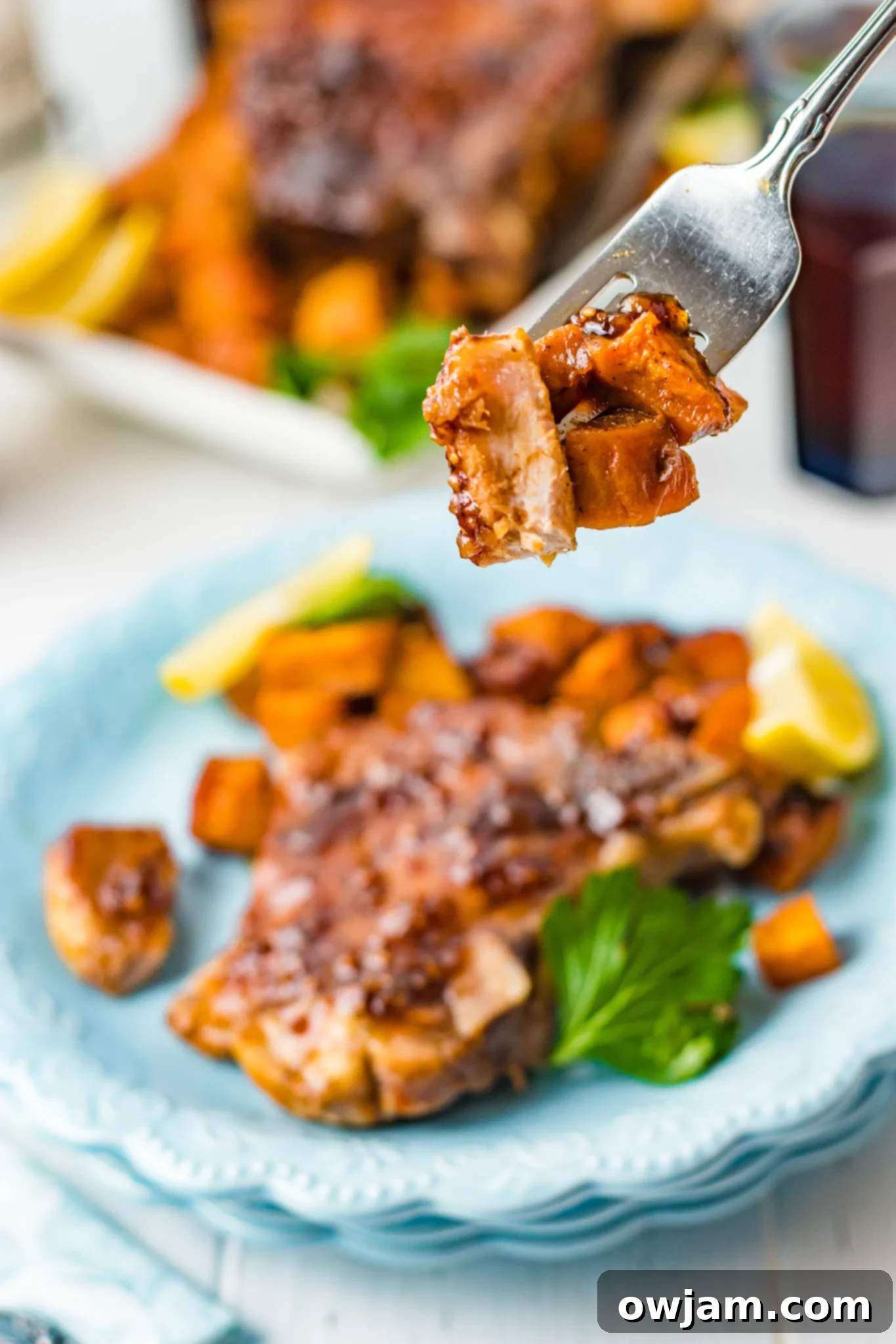 Maple Bourbon Glazed Pork Chops Recipe 6 Maple Bourbon Pork Chops Recipe pork on a fork, showing its juicy texture.