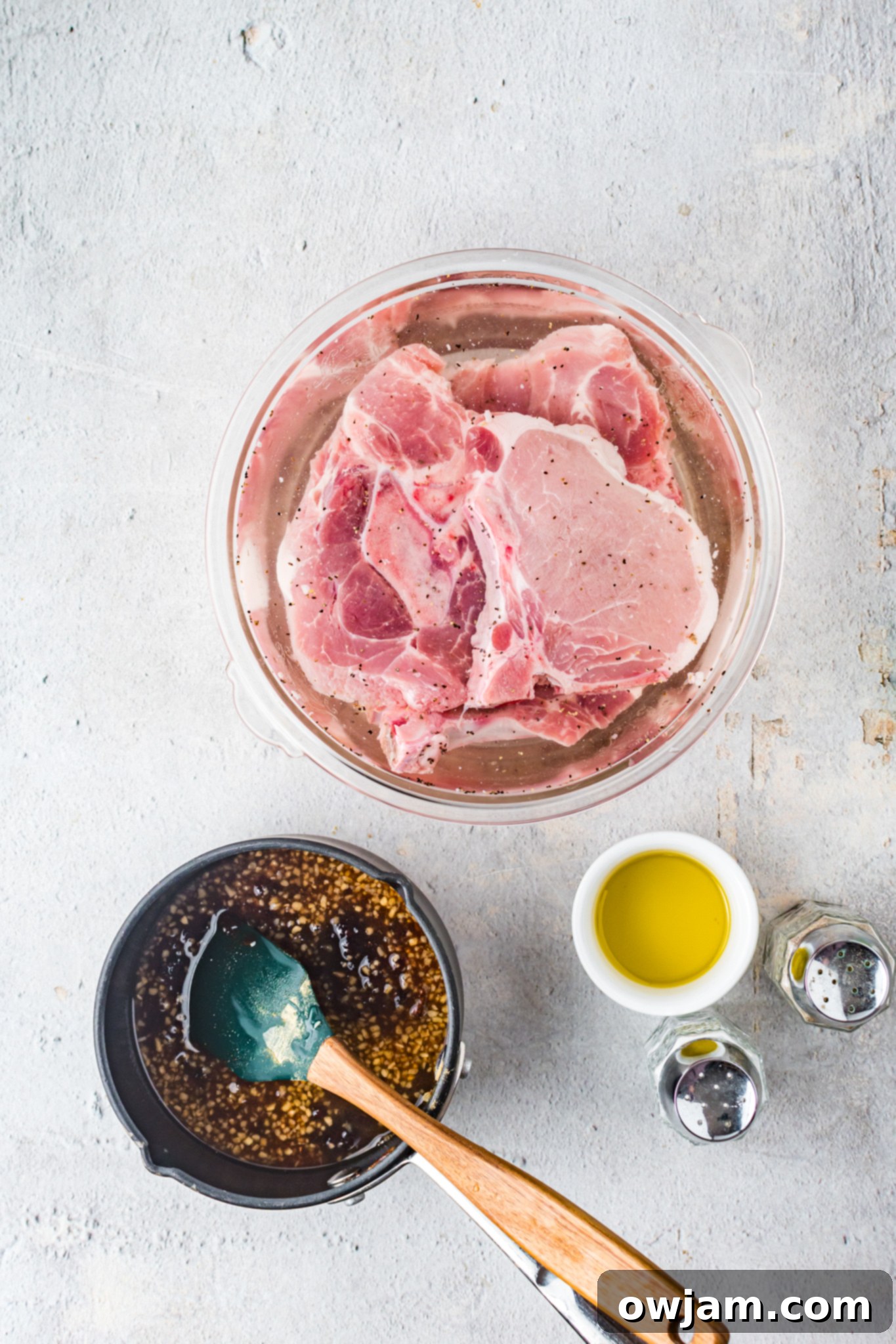 Maple Bourbon Glazed Pork Chops Recipe 7 Maple Bourbon Pork Chops Recipe pork chops soaking in a brining bowl.