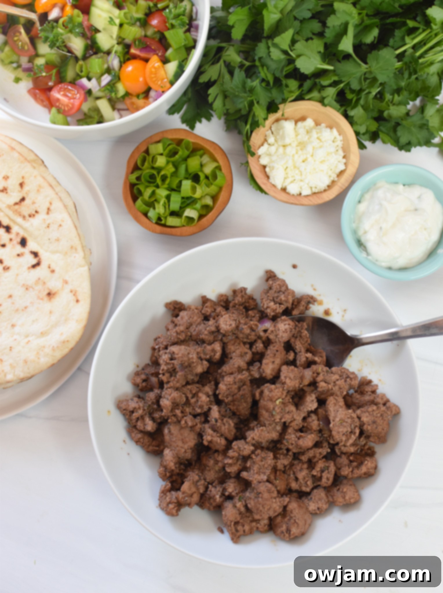 Spiced Lamb Pita Pockets 3 Fresh, high-quality ingredients laid out for the Spiced Ground Lamb Pita Recipe, including vibrant vegetables and aromatic spices.
