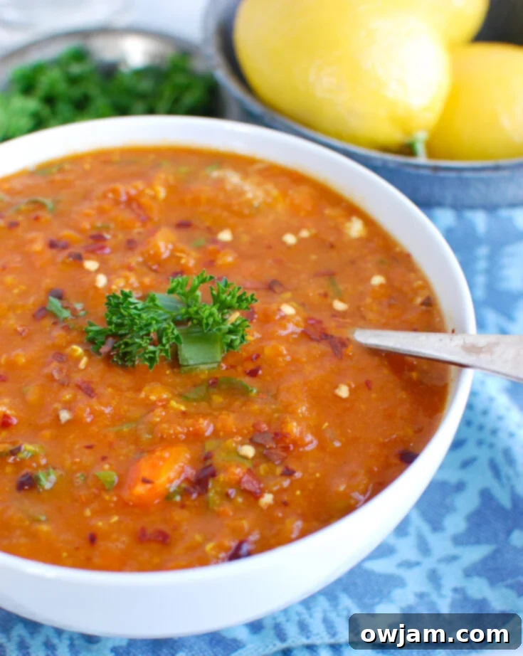Bowl of hearty Slow Cooker Lentil Soup, garnished with fresh parsley