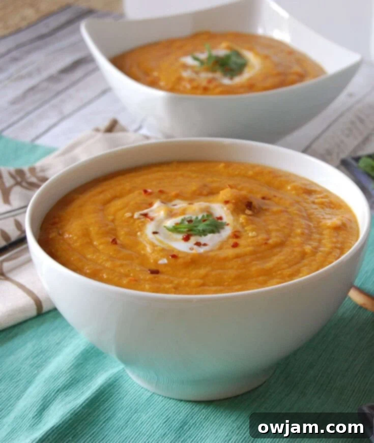 Vibrant Moroccan Carrot Red Lentil Soup with fresh herbs in a ceramic bowl