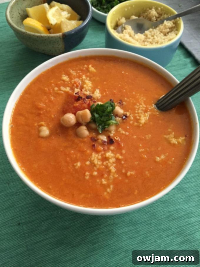 Hearty Moroccan Tomato Couscous Chickpea Soup in a rustic bowl