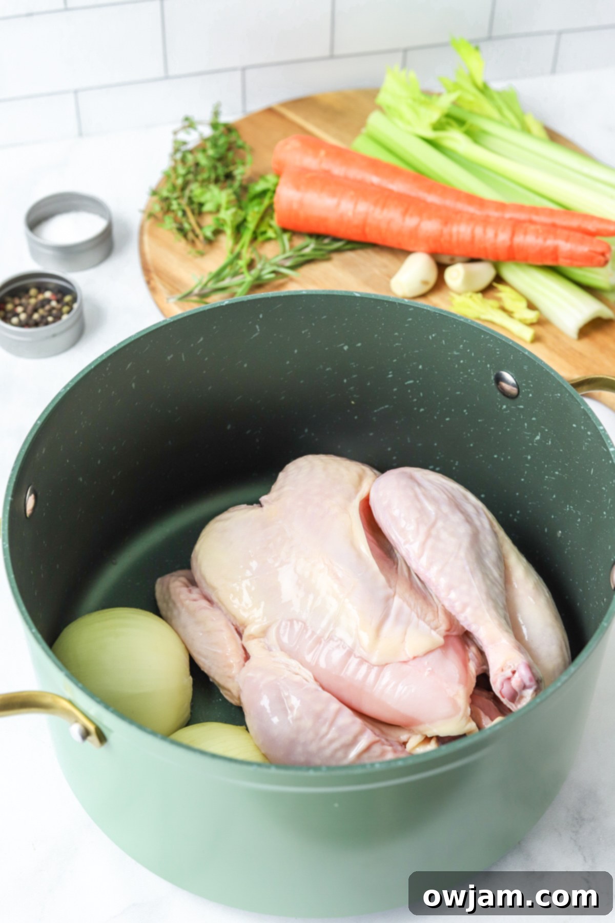 Slow-Simmered Chicken Broth 6 A whole chicken and vegetables browning in a large pot for Homemade Chicken Broth.