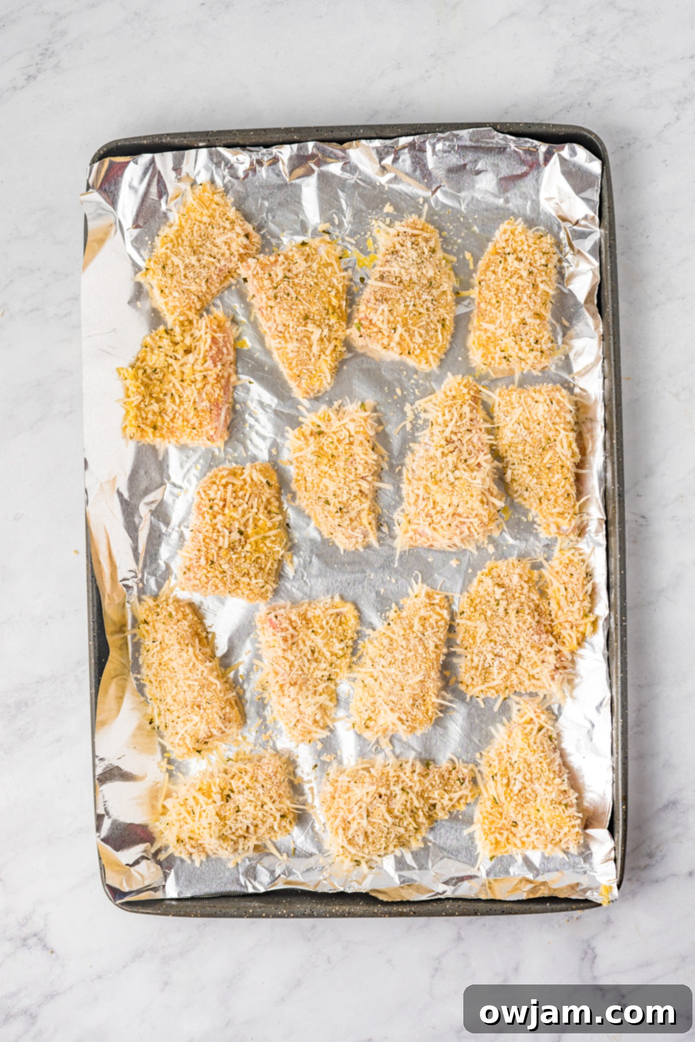 Baked Parmesan Fish Sticks neatly arranged on a baking sheet, golden and crisp.
