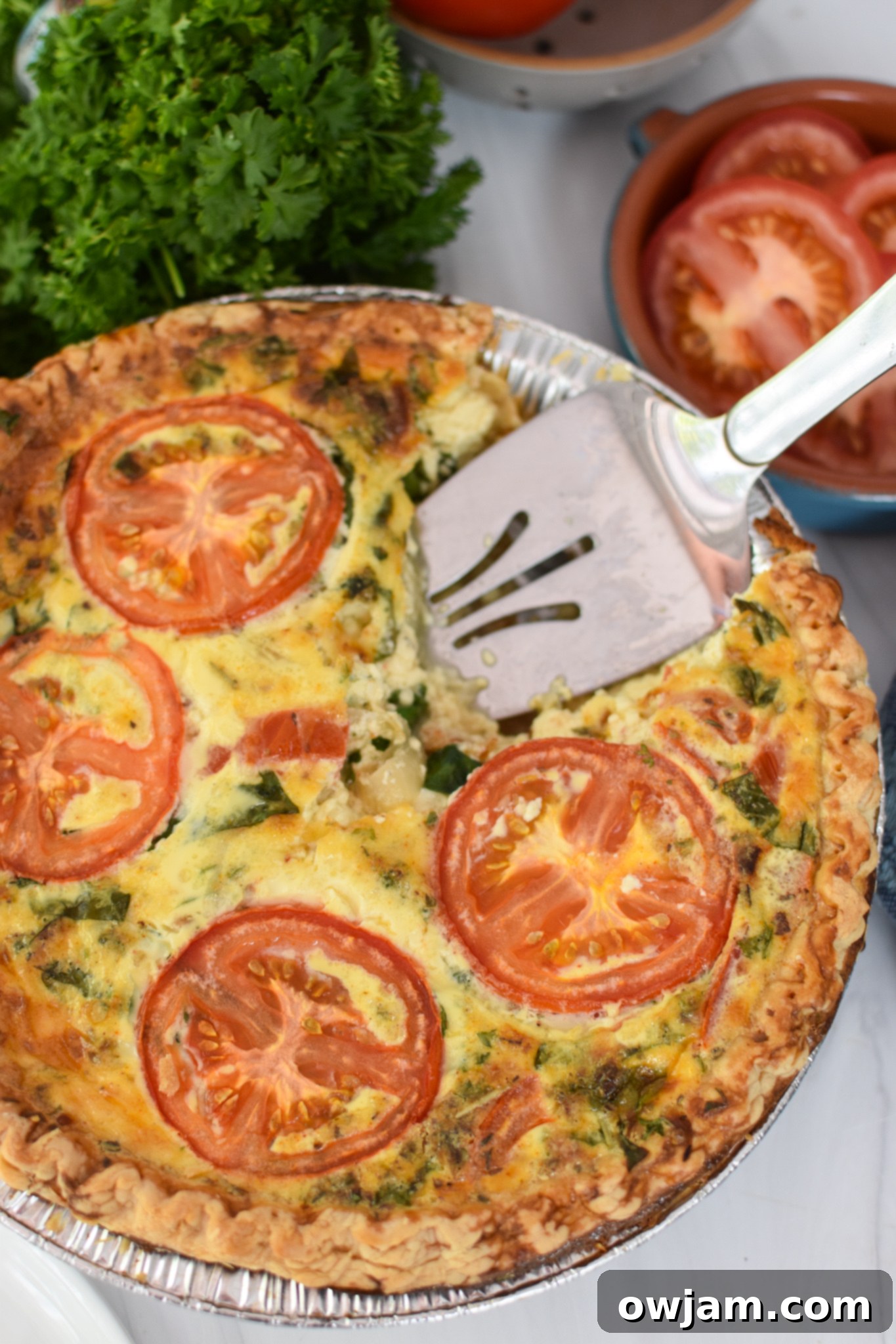 Caprese Quiche Lorraine Delight 4 Caprese Quiche Lorraine Recipe with pie server.