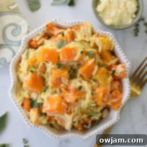 Golden Cheesy Butternut Squash Orzo 9 Cheesy Butternut Squash Orzo in a flower bowl.