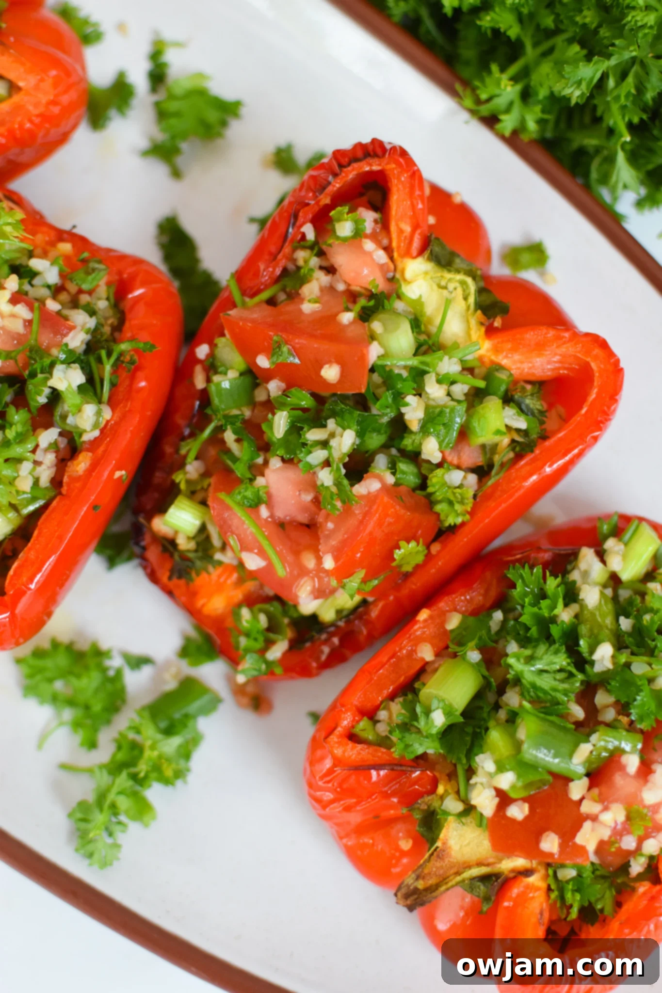 Vegan Stuffed Peppers Recipe on a white platter, showcasing the fresh tabbouleh filling.