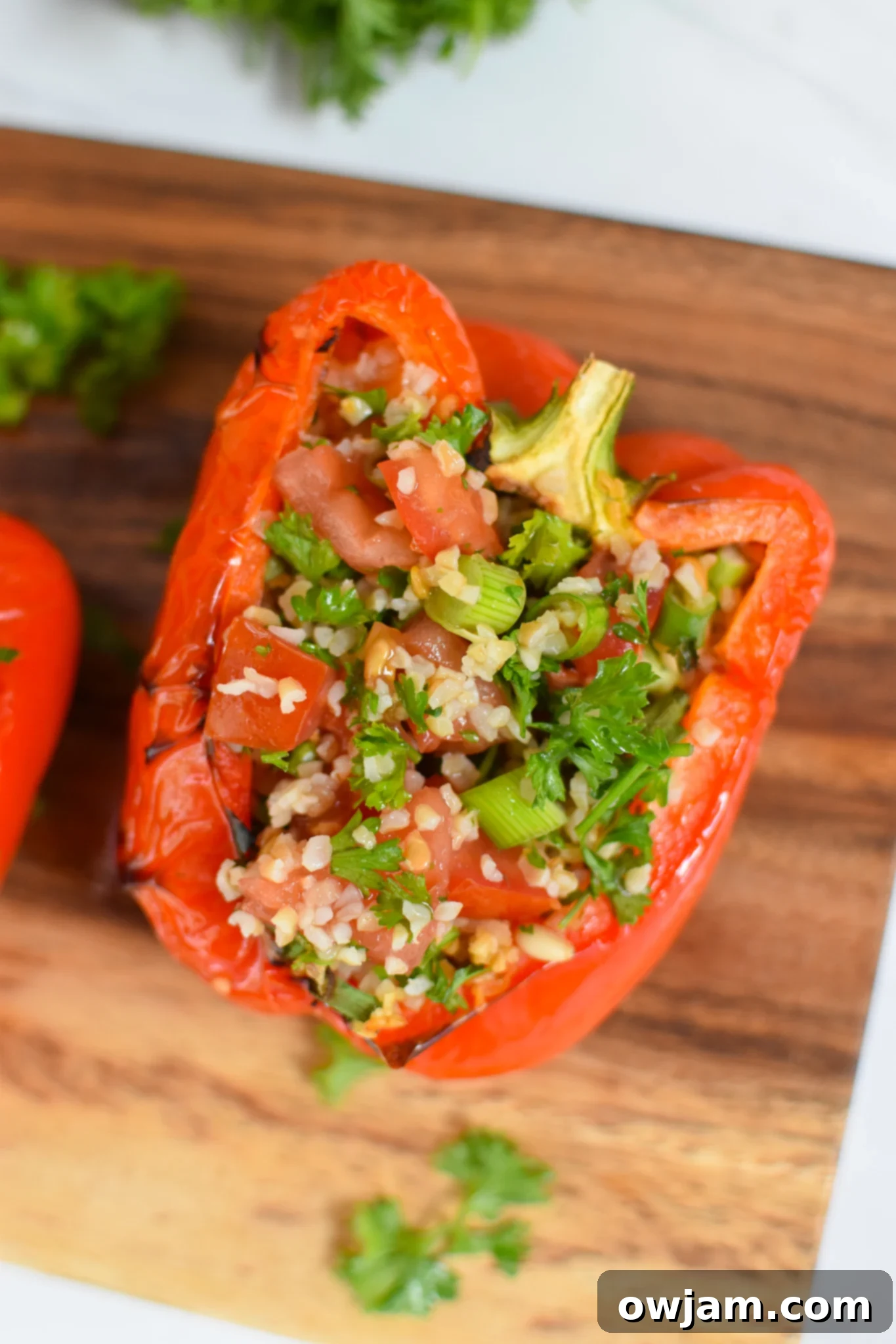 Zesty Tabbouleh Stuffed Peppers 4 Vegan Stuffed Peppers Recipe with halved peppers on a cutting board, ready for stuffing.